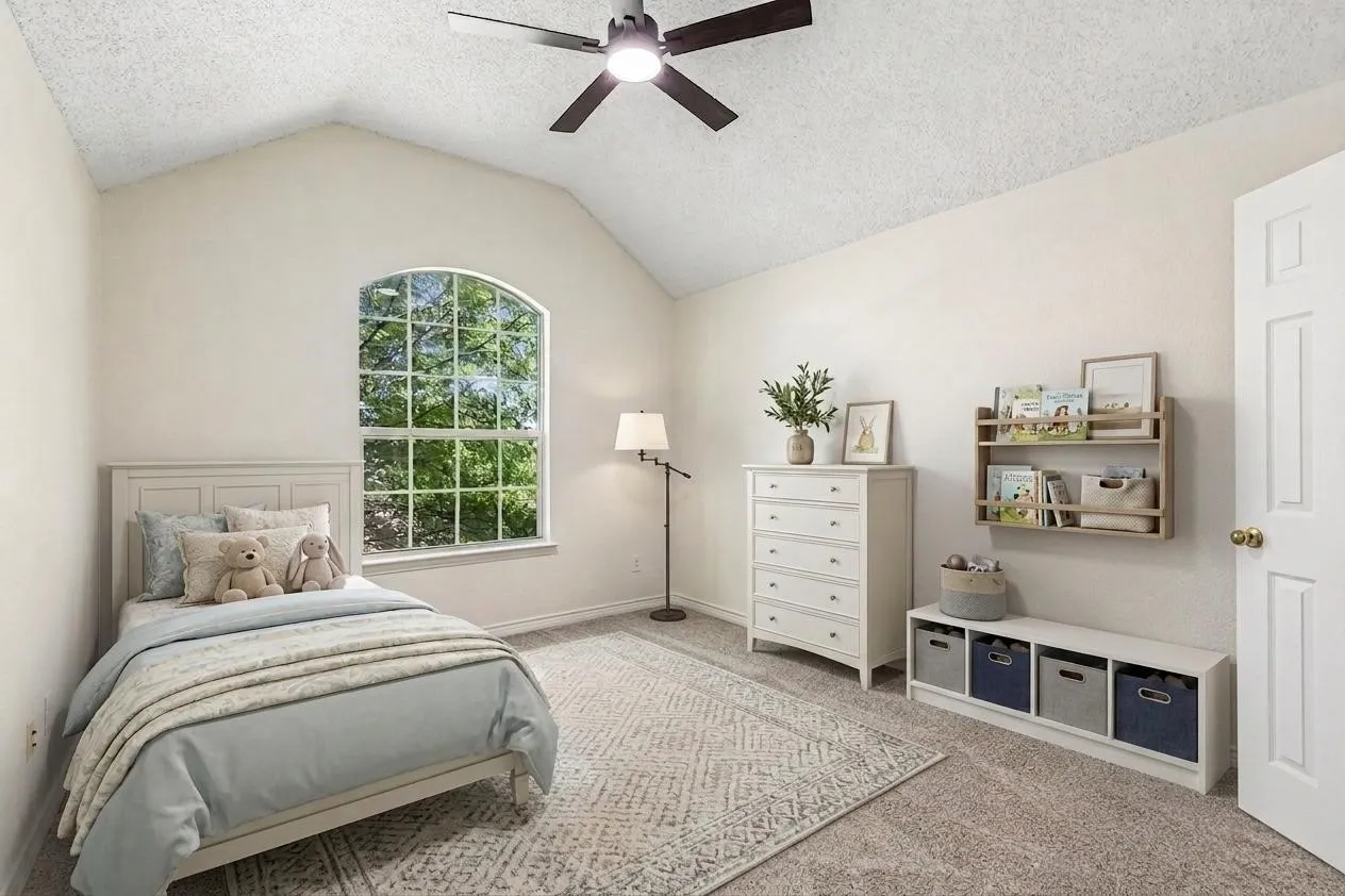 One of three upstairs bedrooms, featuring brand new carpet, fresh paint and a new ceiling fan with light kit. *Virtually Staged*