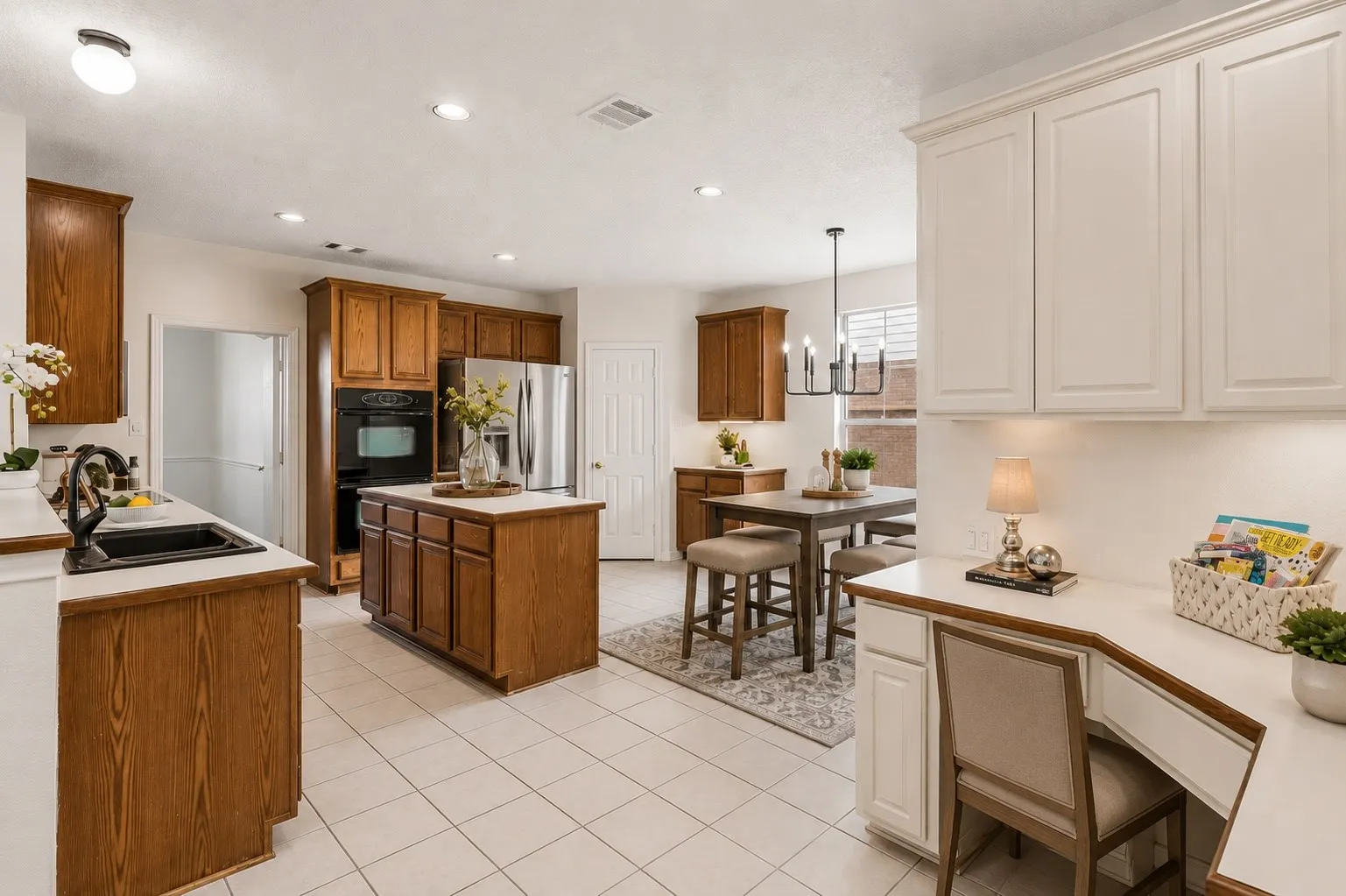 Spacious kitchen with abundant cabinetry and workspace opens directly to the breakfast nook and soaring family room.*Virtually Staged*