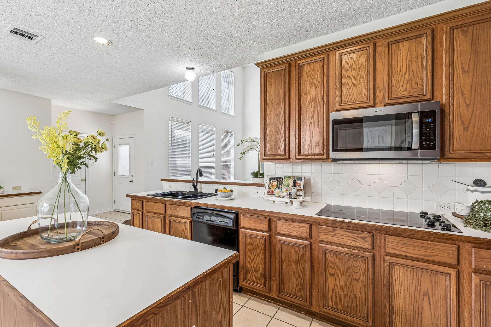 Open kitchen maintains sightlines to the family room and breakfast area, with gas plumbing available for a future cooktop conversion.
