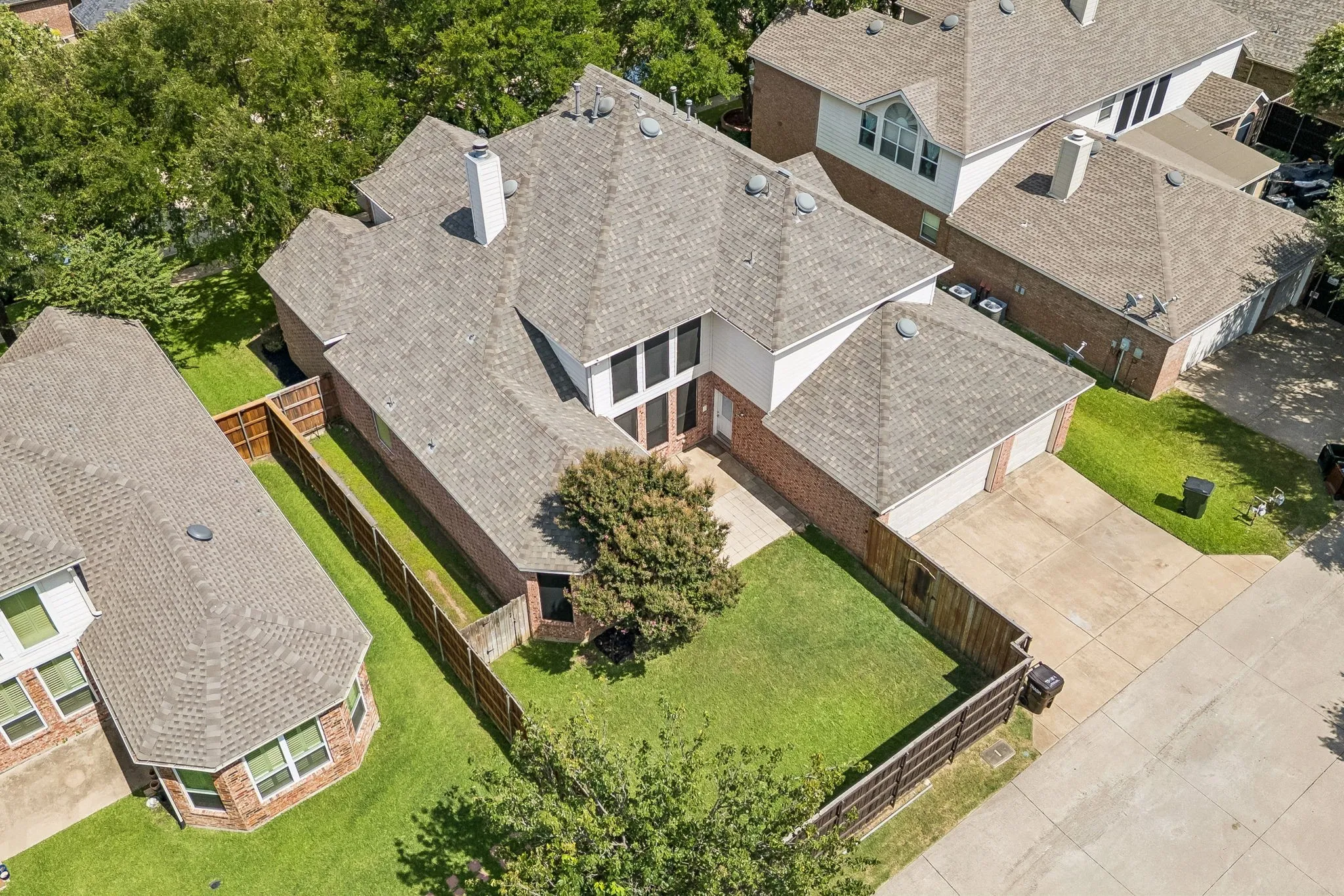 Aerial view highlights the home's spacious lot, established trees and 3-Car Garage.
