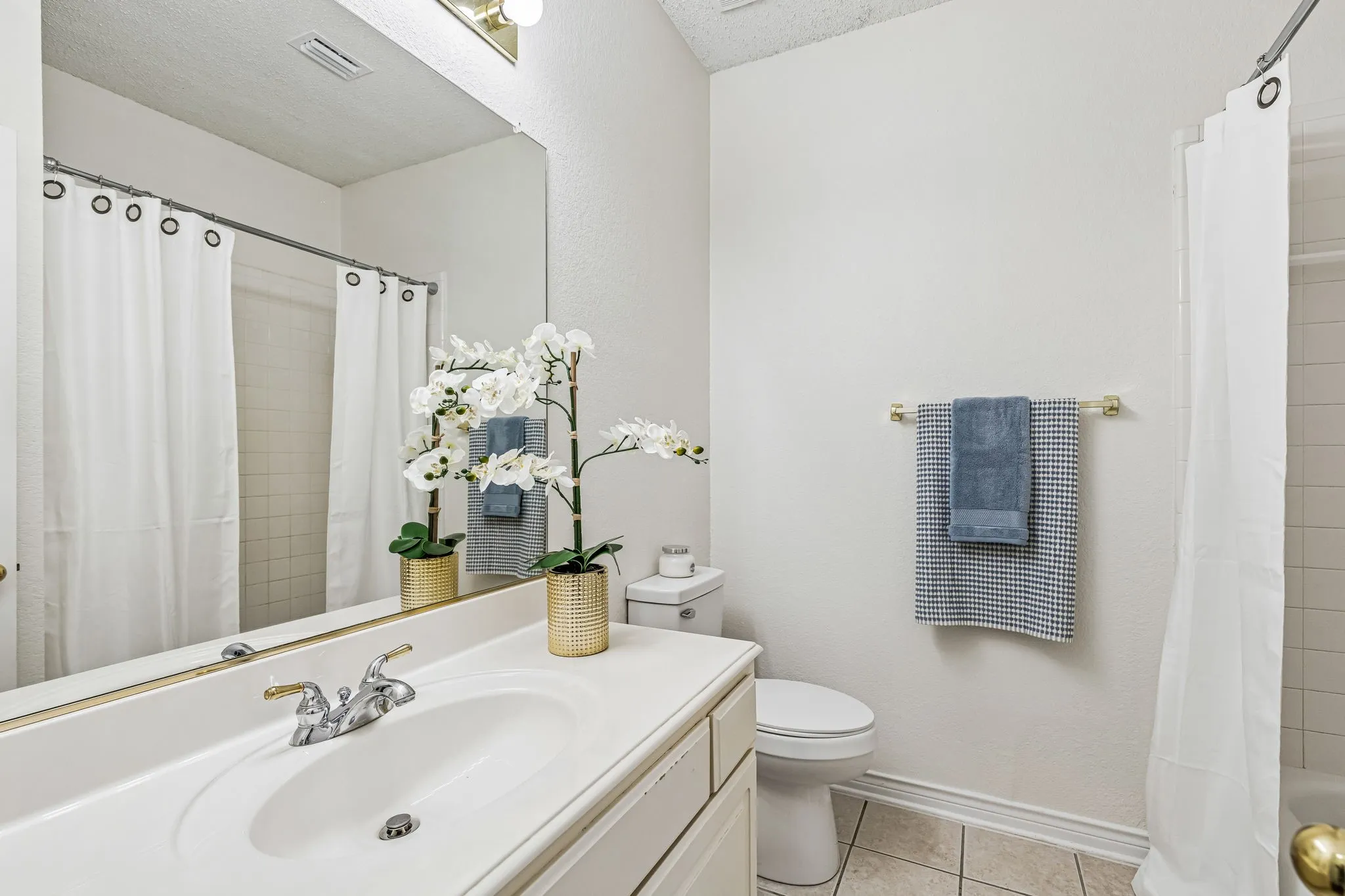 Full bathroom on the first floor conveniently serves the secondary downstairs bedroom and guests.
