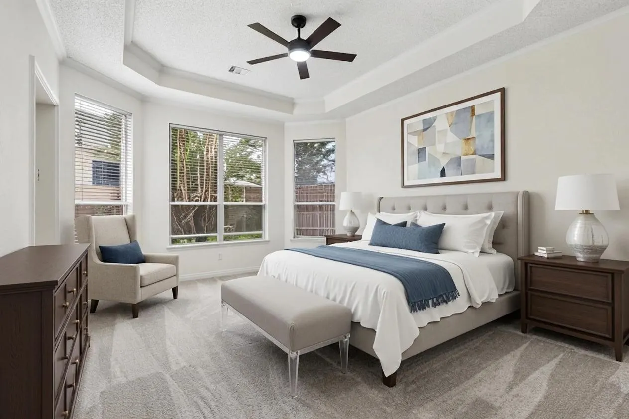 Spacious primary suite is privately located on the first floor and features tall ceilings and brand new carpet. *Virtually Staged*