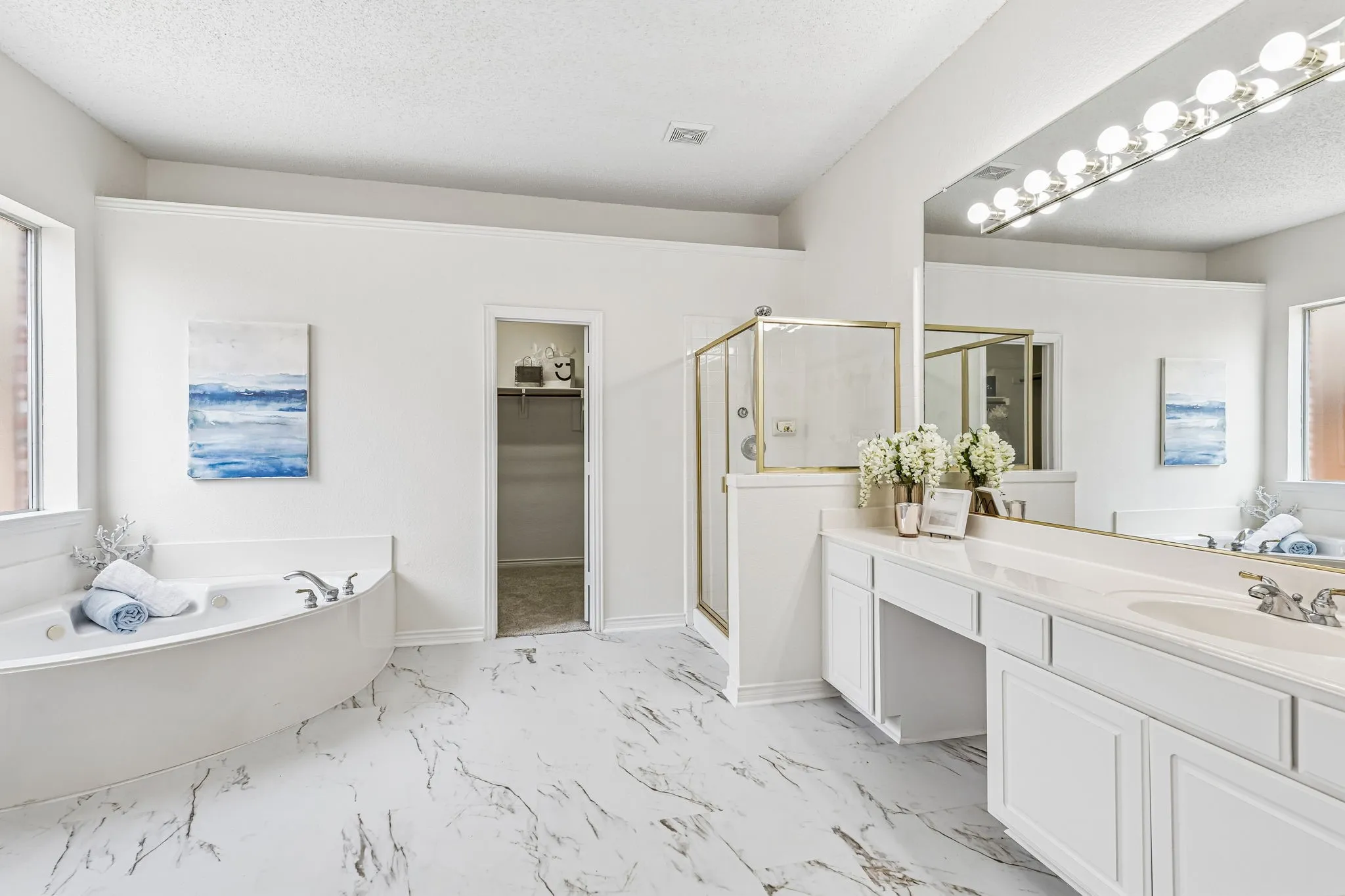 Primary bath offers generous counter space, dual vanities and a spacious layout ready for future personalization.
