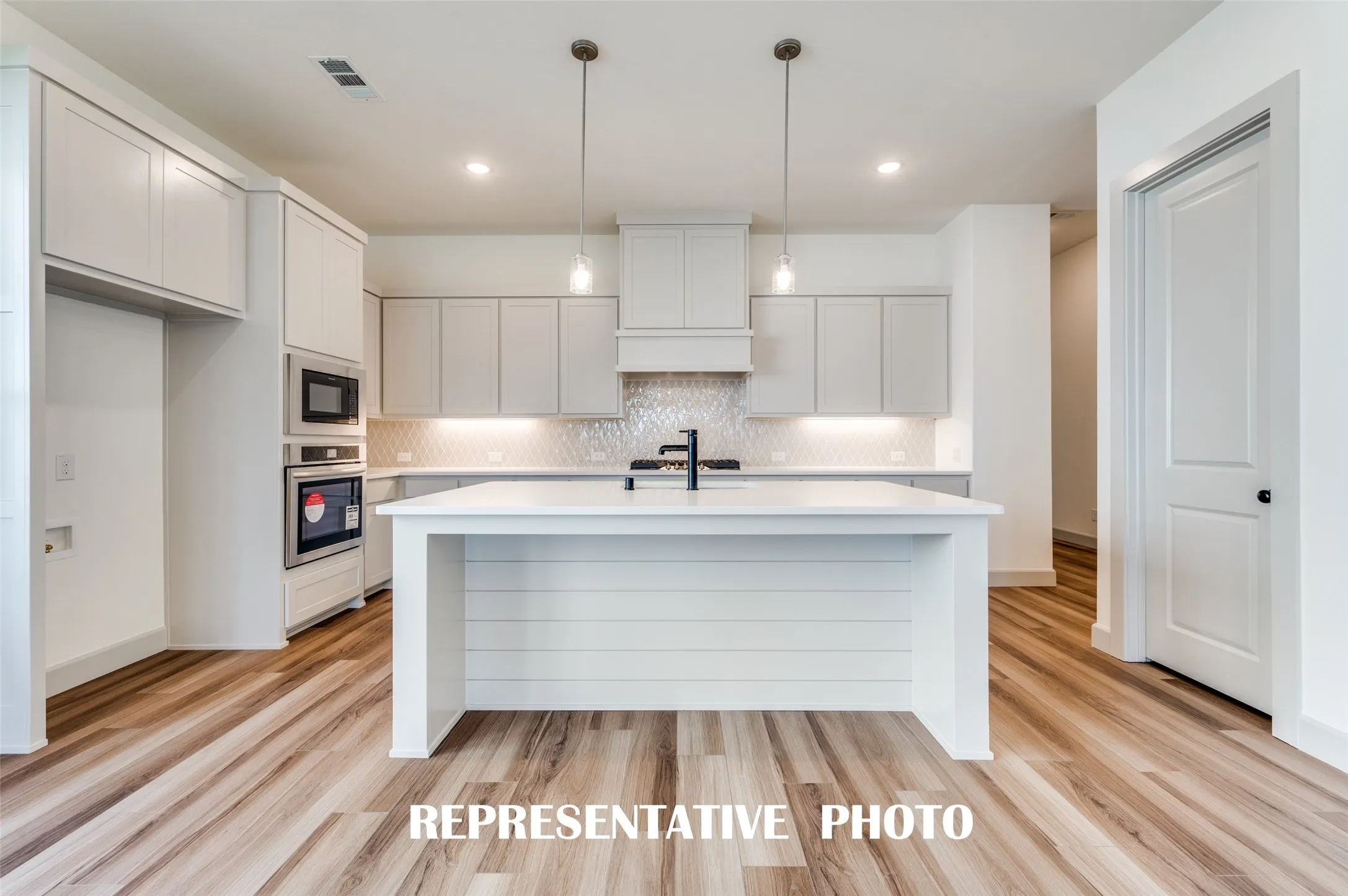 The large kitchen island is the perfect place for a quick family meal or after school homework station.