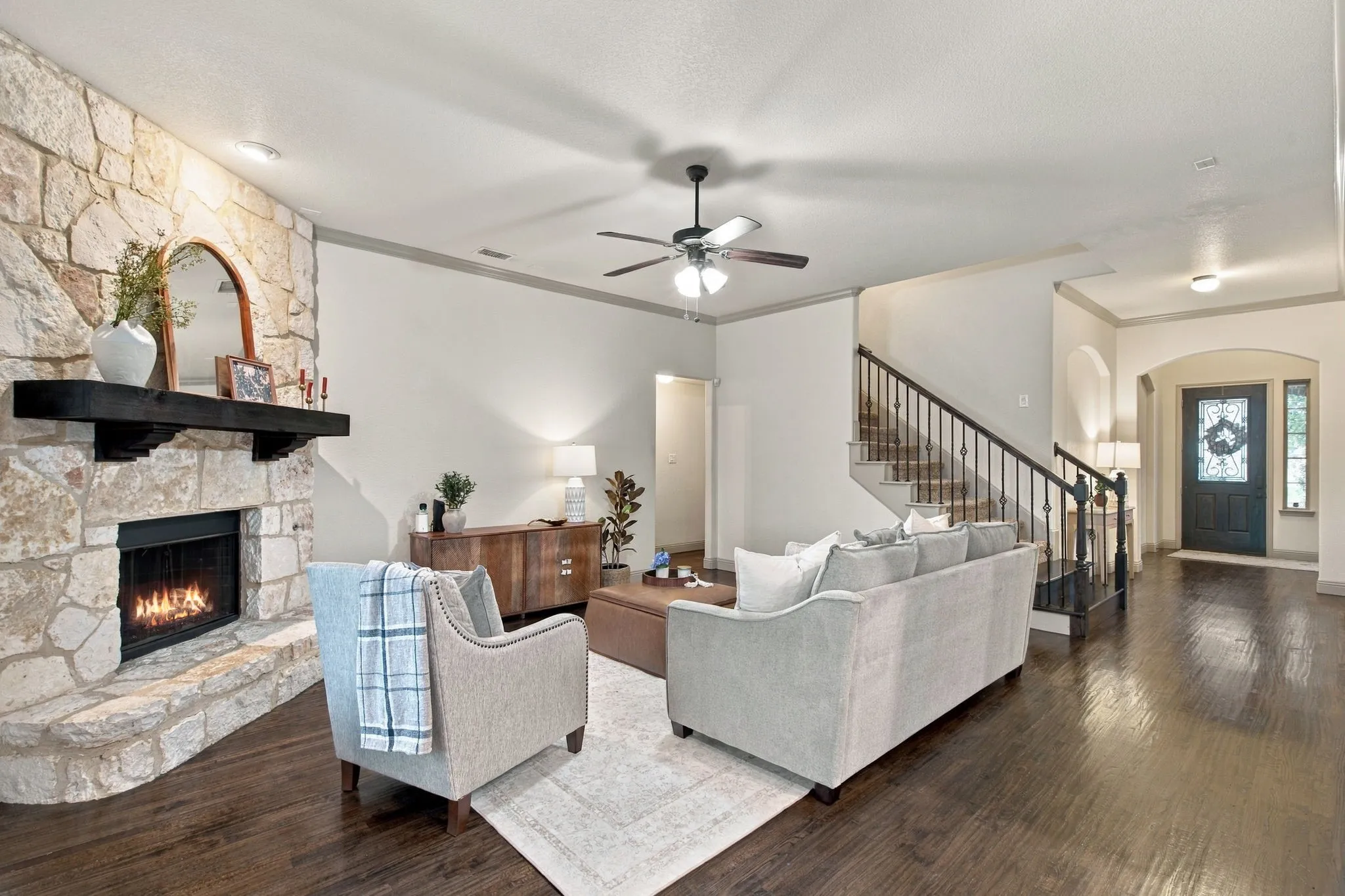 COZY LIVING ROOM WITH STONE FIREPLACE AND LIGHT AND BRIGHT WALLS
