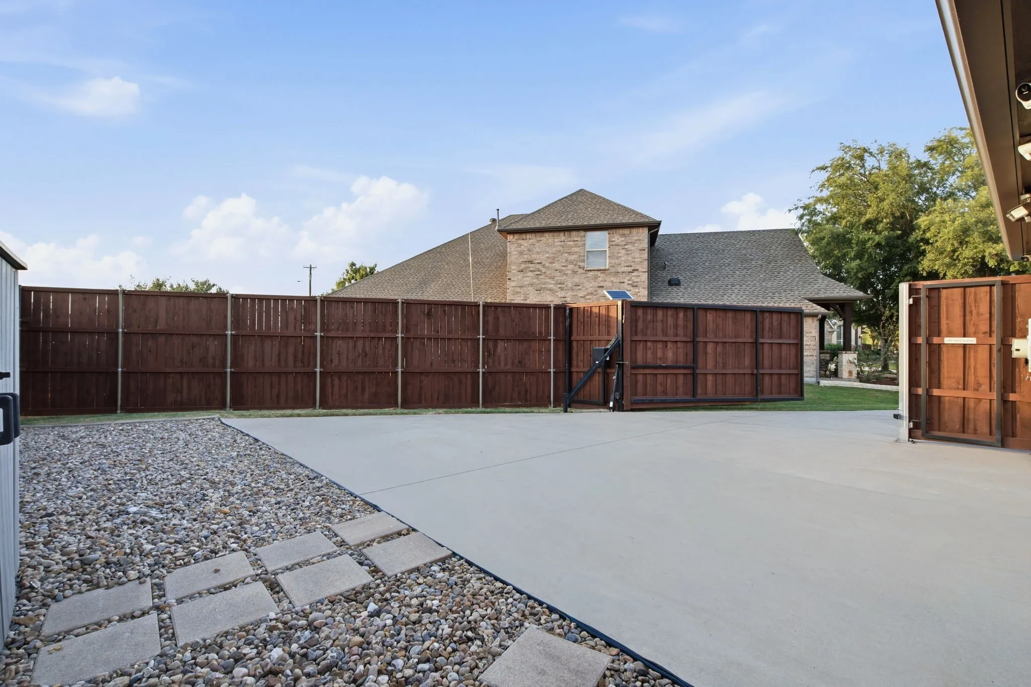 EXTRA DRIVEWAY CONCRETE SPACE THAT IS ALL FENCED IN