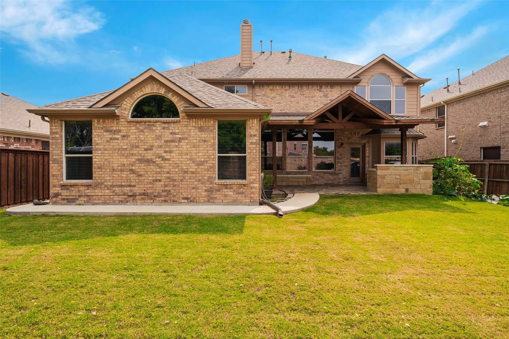 Rear view of house featuring a yard and a patio