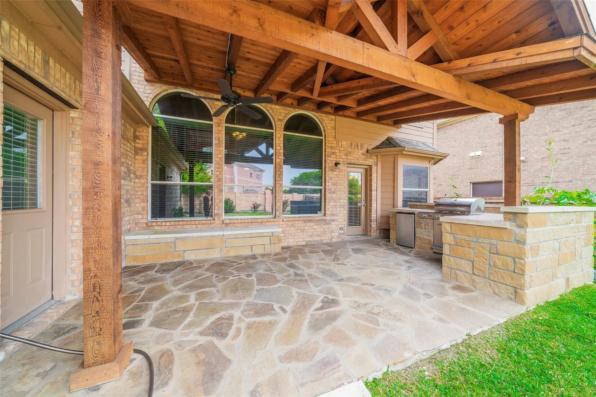 View of patio featuring area for grilling, ceiling fan, and a grill
