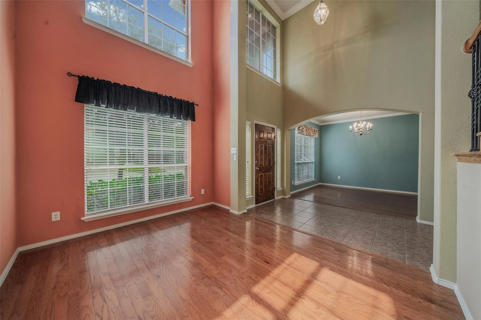 Entrance foyer with crown molding, hardwood / wood-style floors, and plenty of natural light