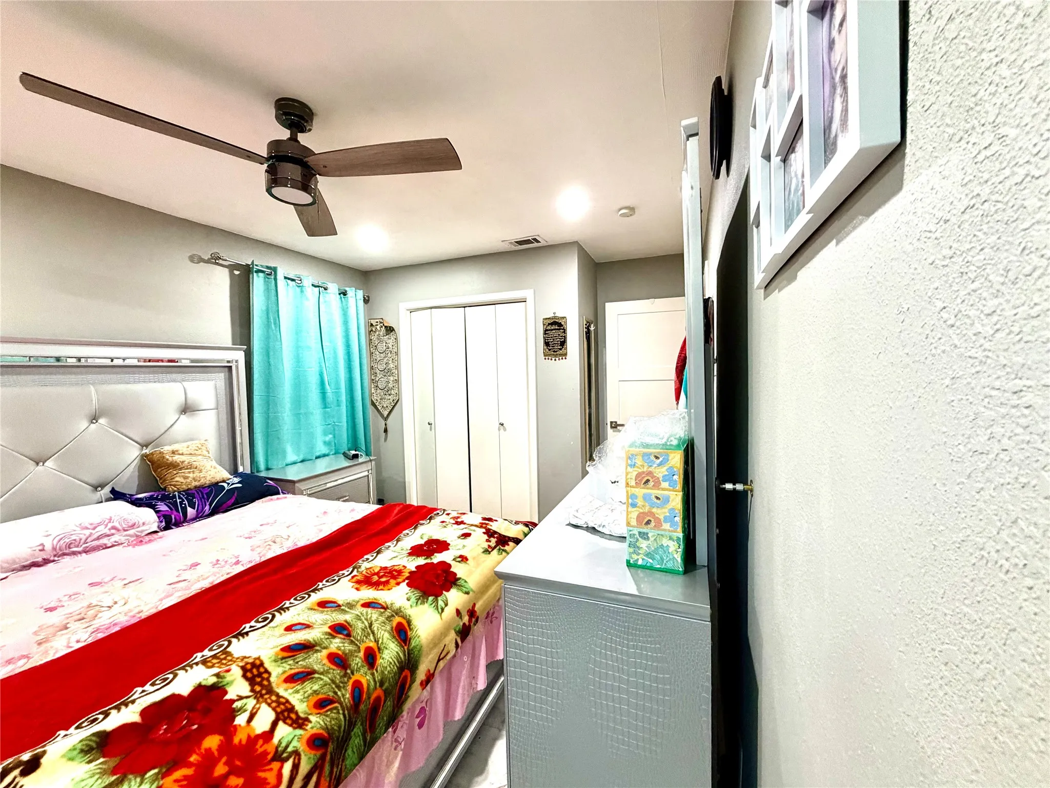 Bedroom featuring a ceiling fan with wood-finish blades, recessed lighting, and a double-door closet