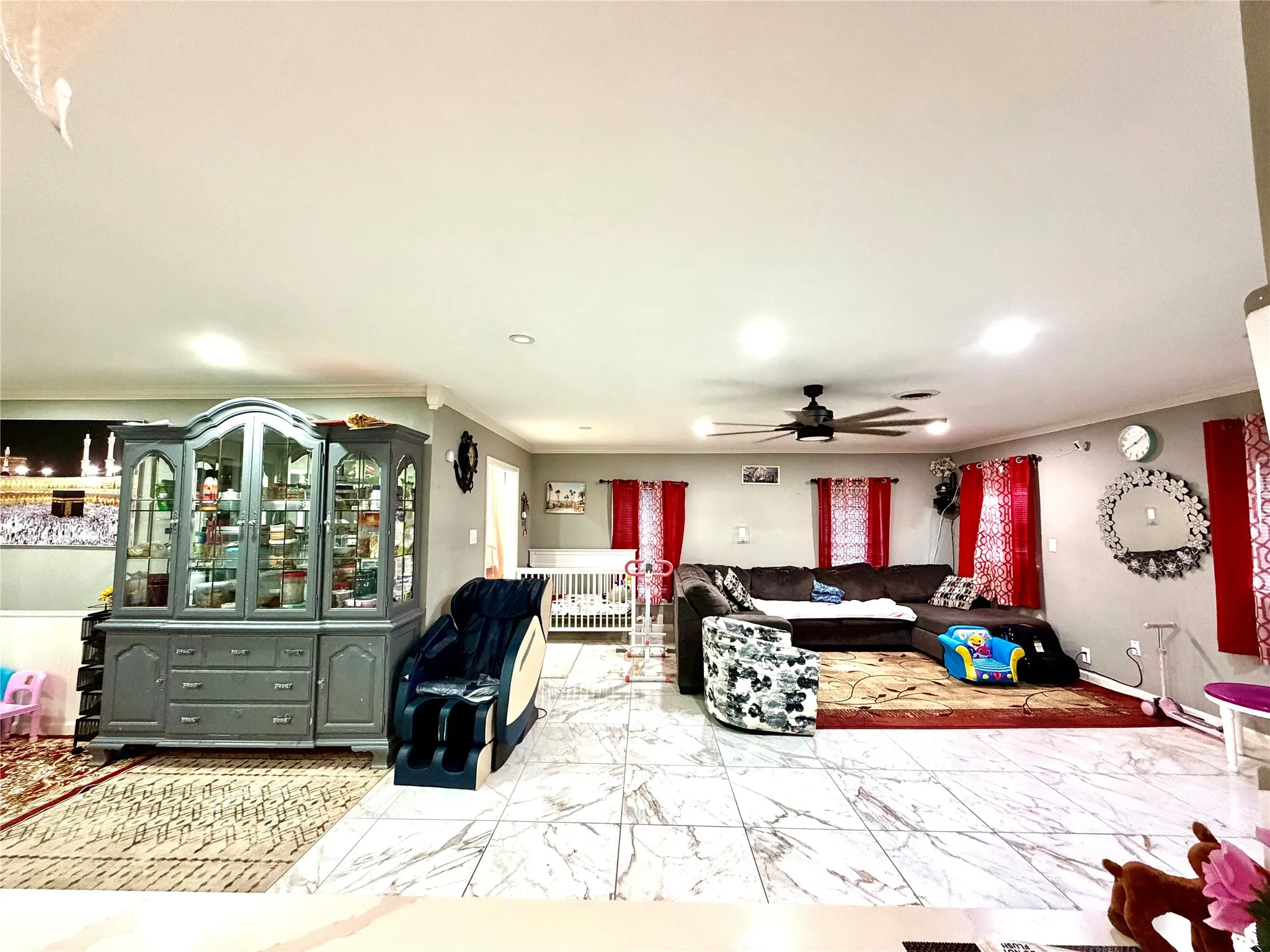 Spacious interior featuring marble-look flooring, neutral wall tones, and recessed lighting