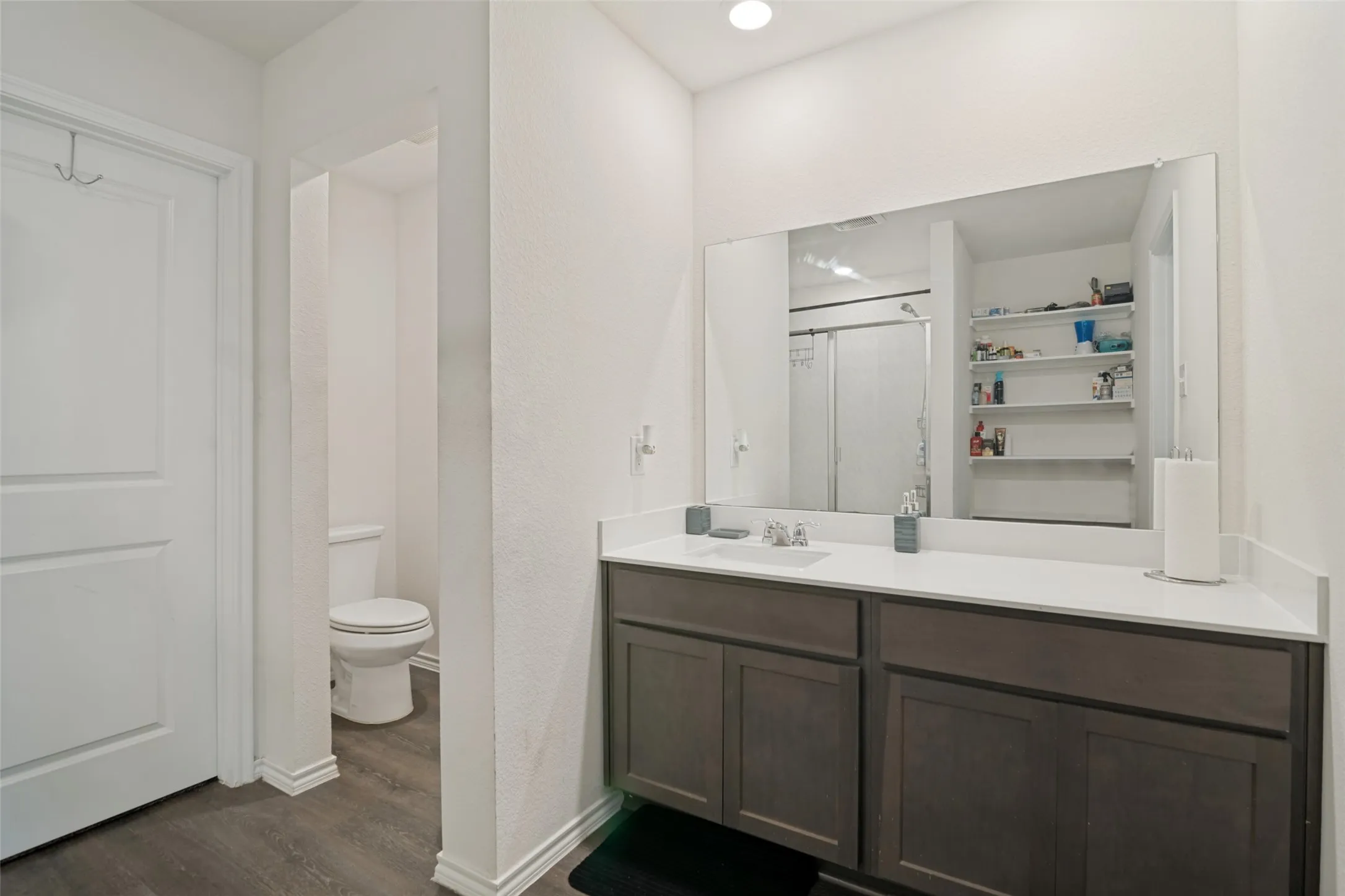 Dual-sink vanity with a white countertop and wood-finish cabinetry
