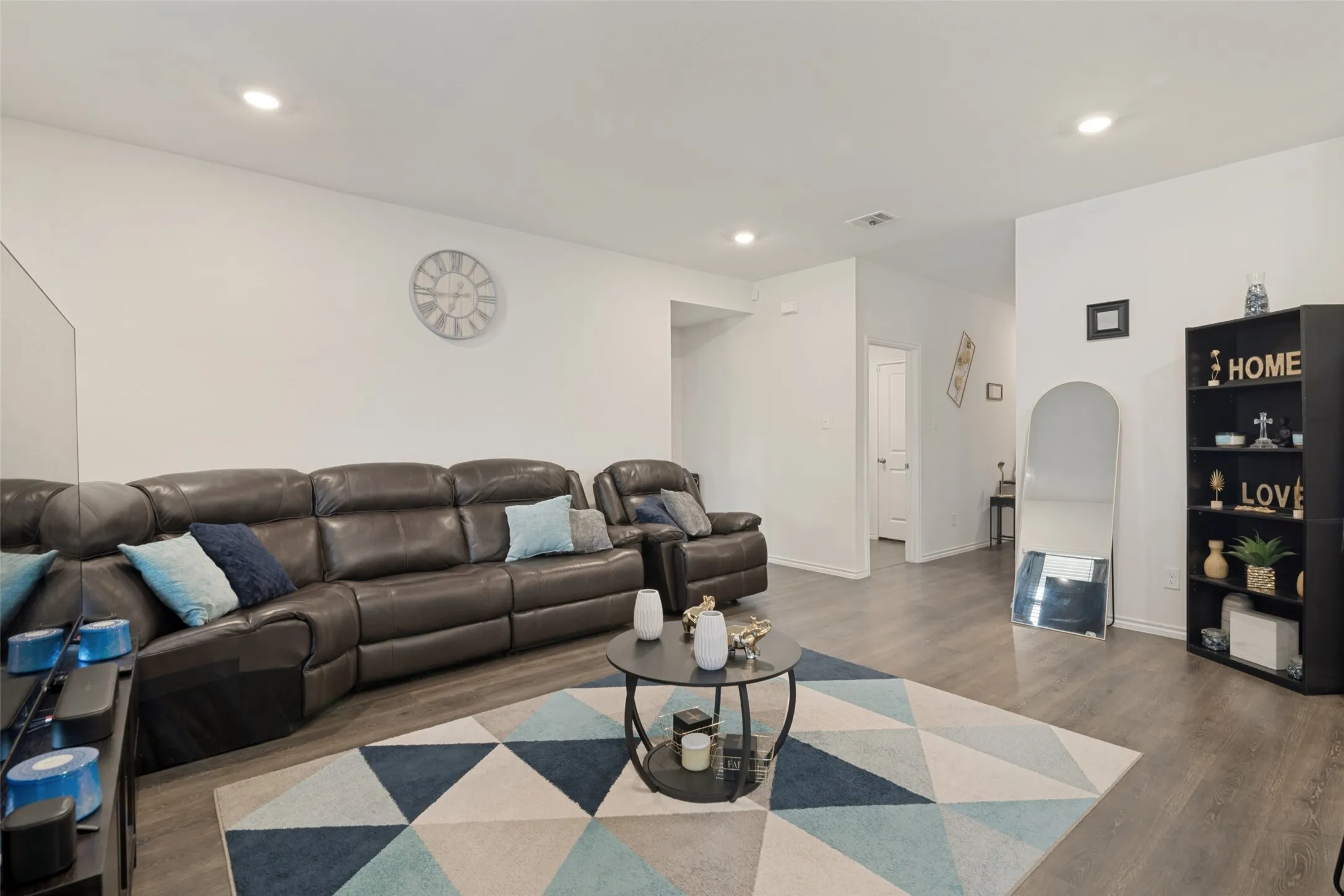 Recessed lighting illuminates an open concept space featuring wood-finish flooring
