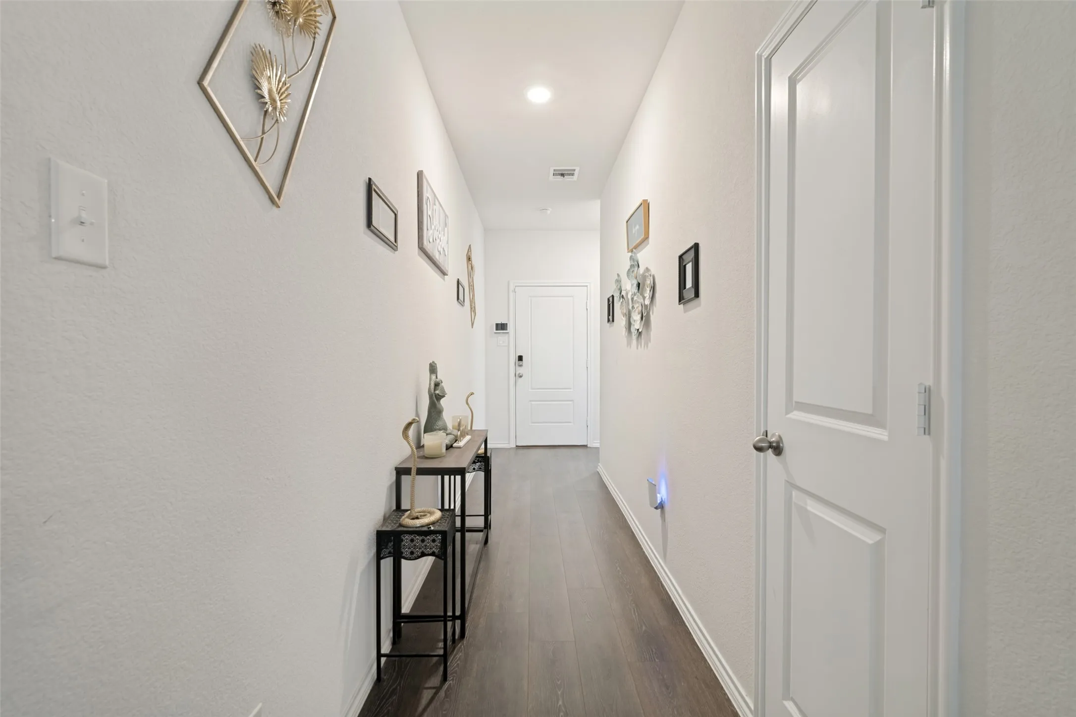 Recessed lighting, wood-finish flooring, and white paneled doors