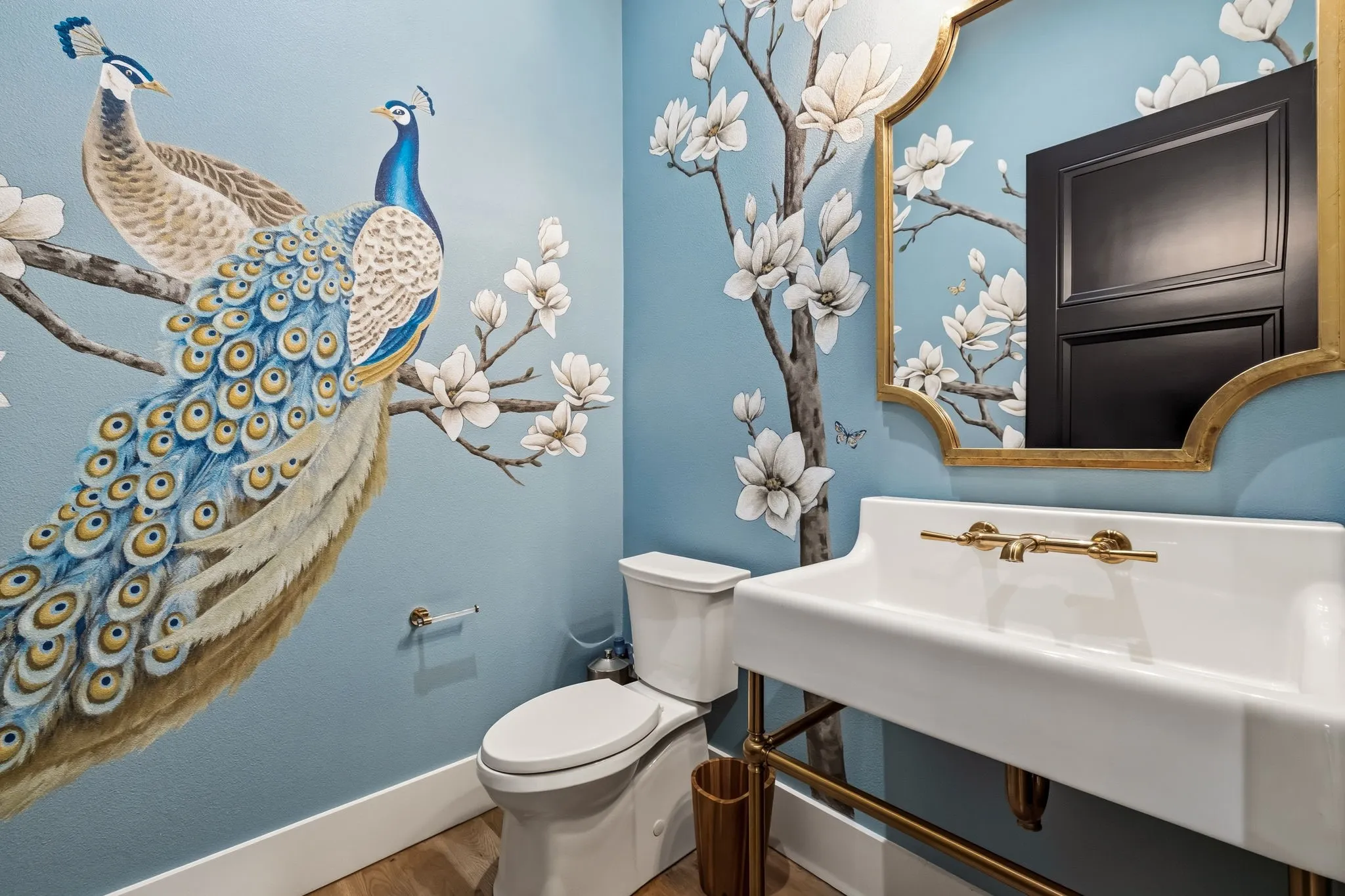 Wall-mounted ceramic sink with gold-tone hardware