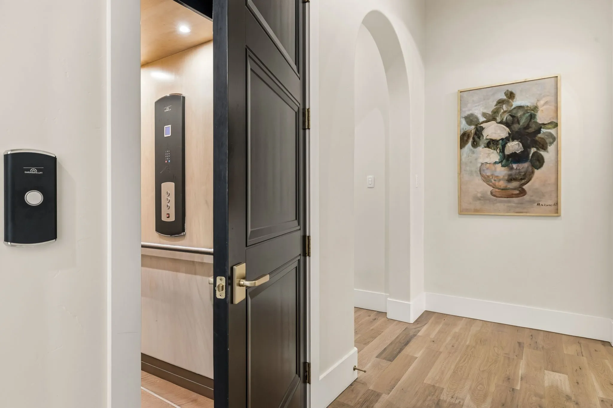 In-home elevator with wood-paneling and control panel