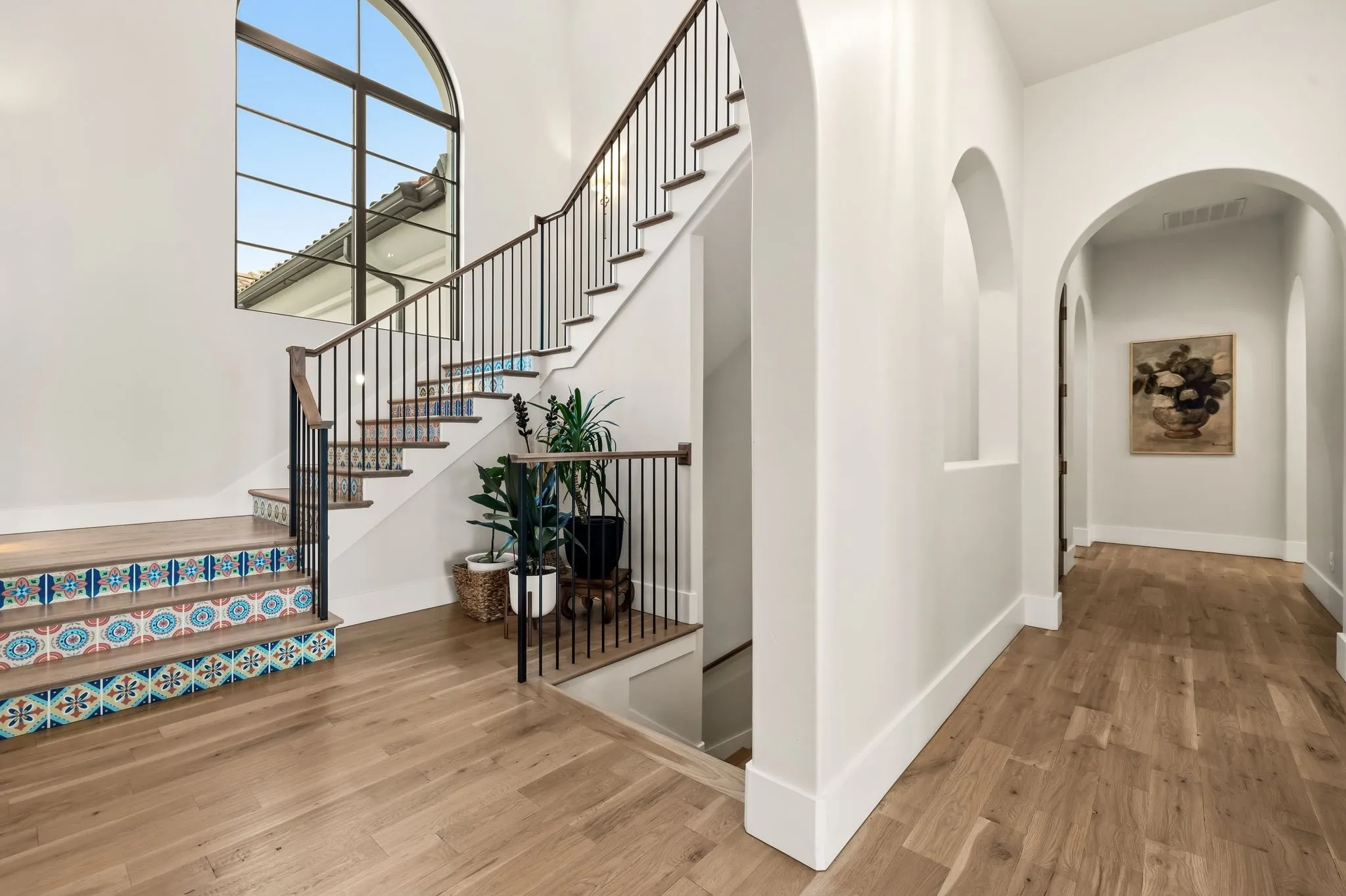 Arched entryway with wood-finish flooring