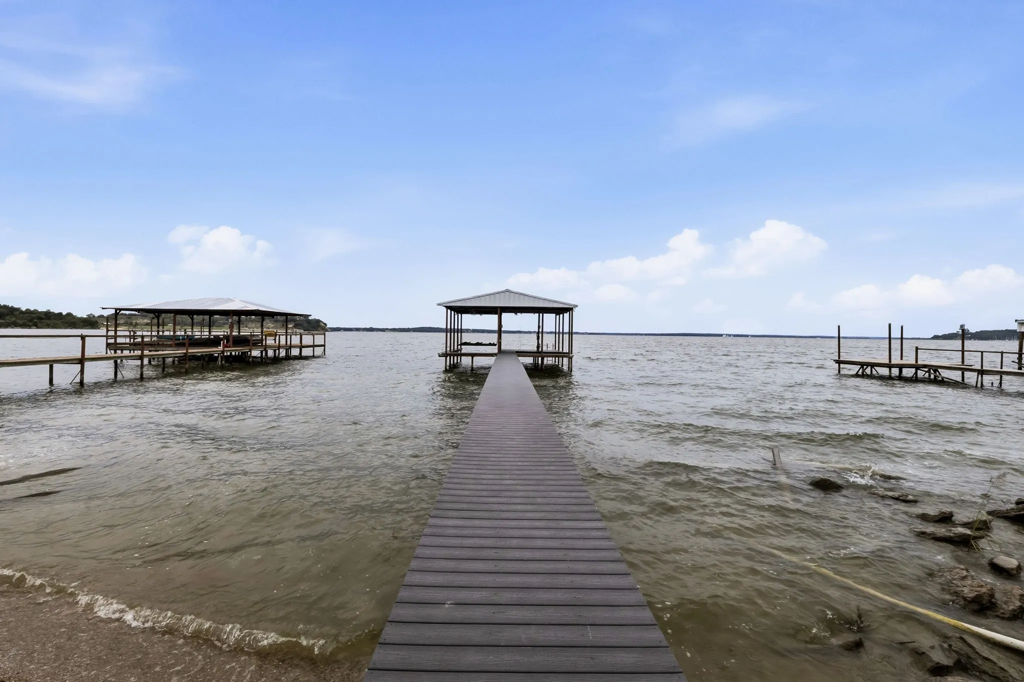 Waterfront property featuring a private boat dock, covered boat slip, and direct water access