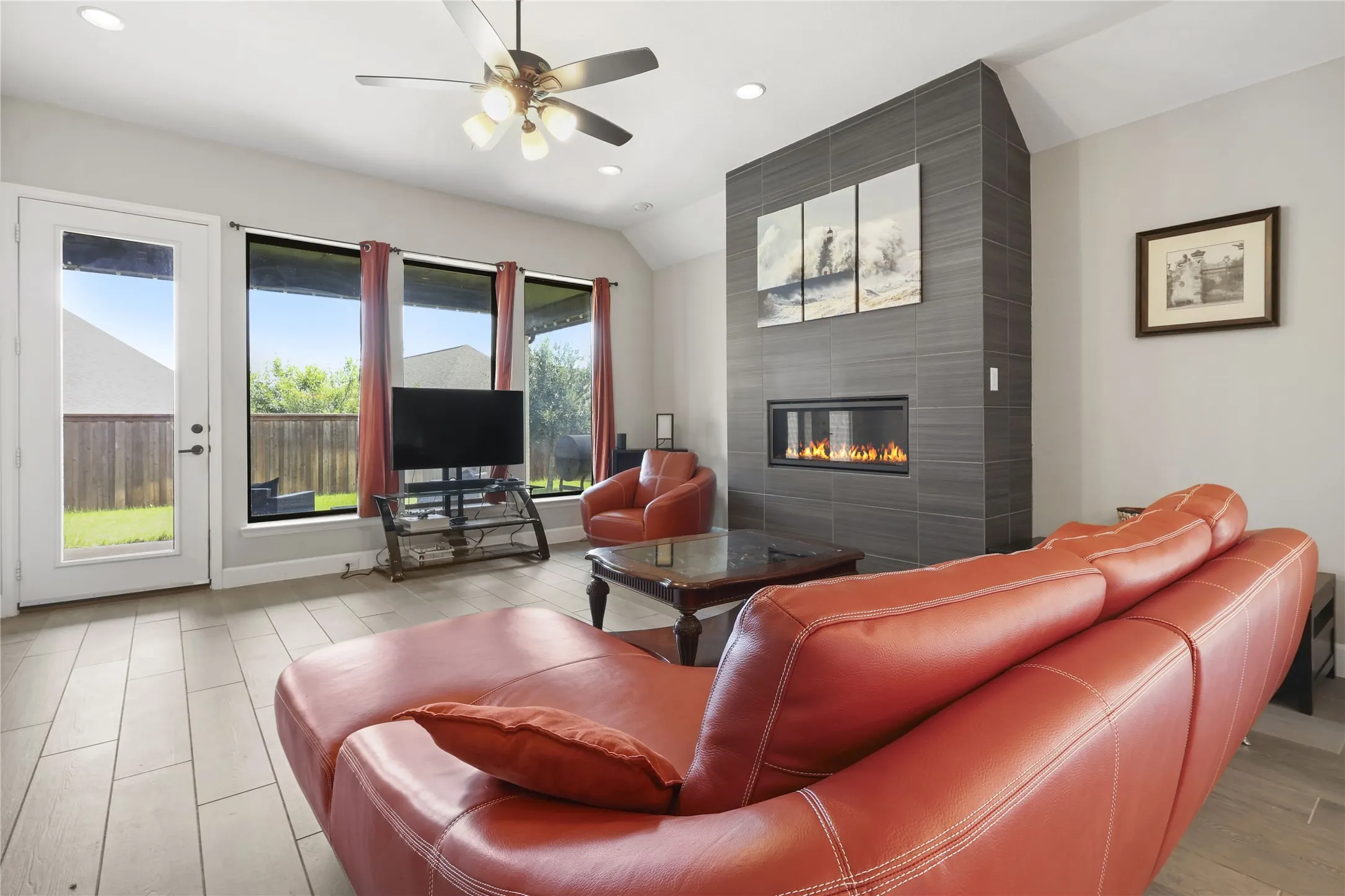 Floor-to-ceiling tiled fireplace with an integrated linear fire feature