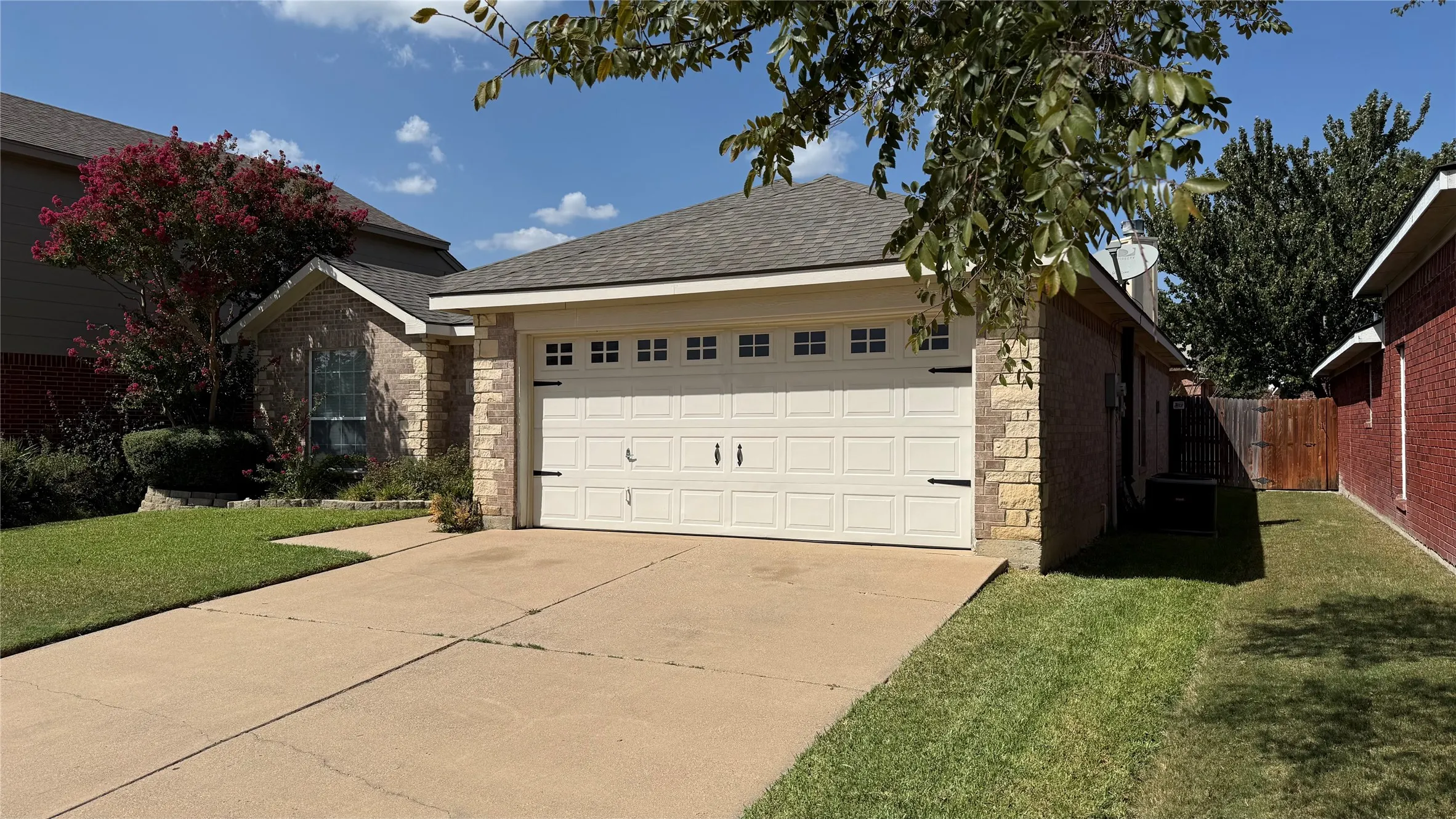 Brick and stone facade with a paneled garage door
