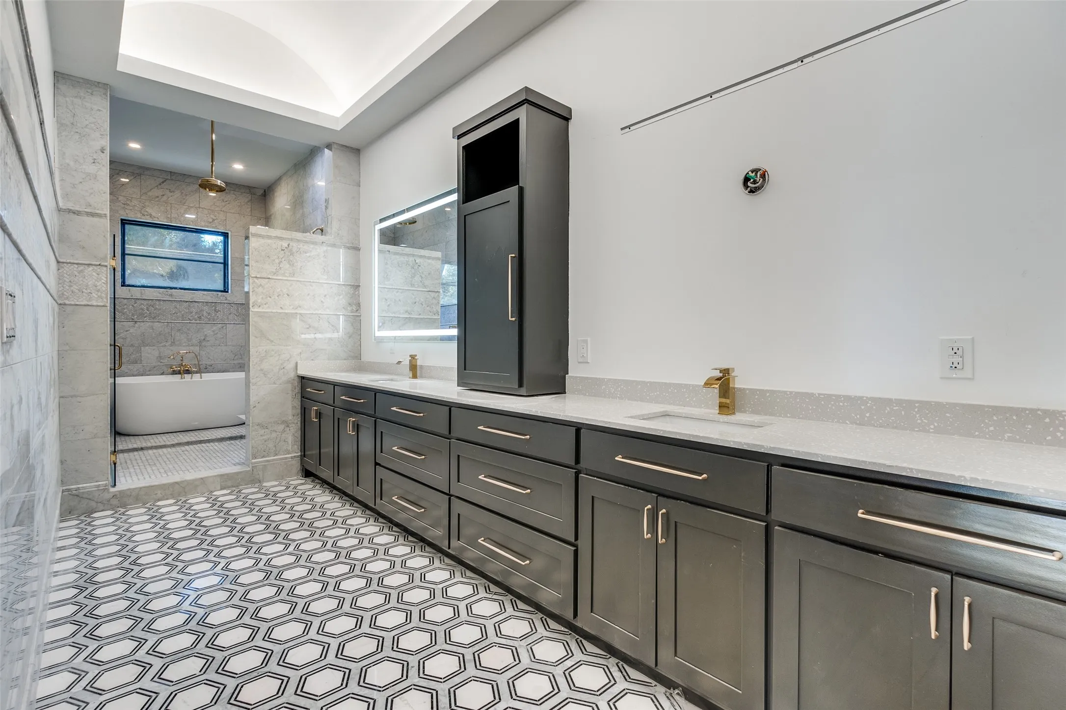 Dual vanity with gold-finish fixtures and light-colored countertops
