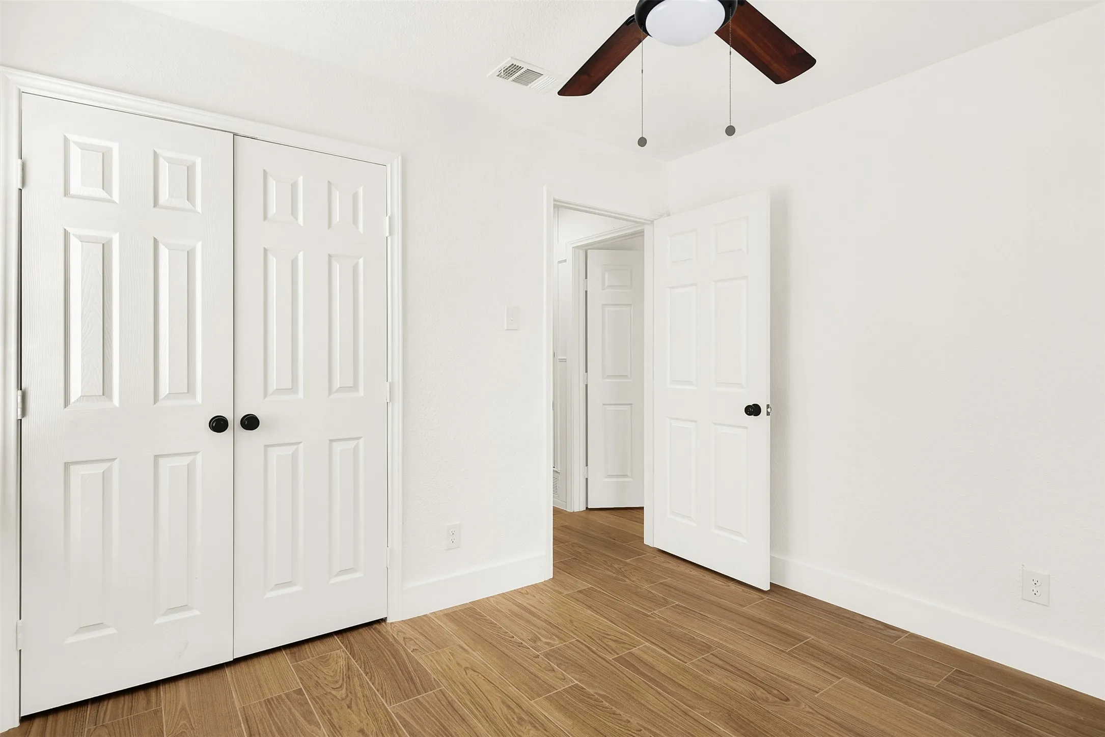 Master Bedroom with light wood-type flooring, and large closet