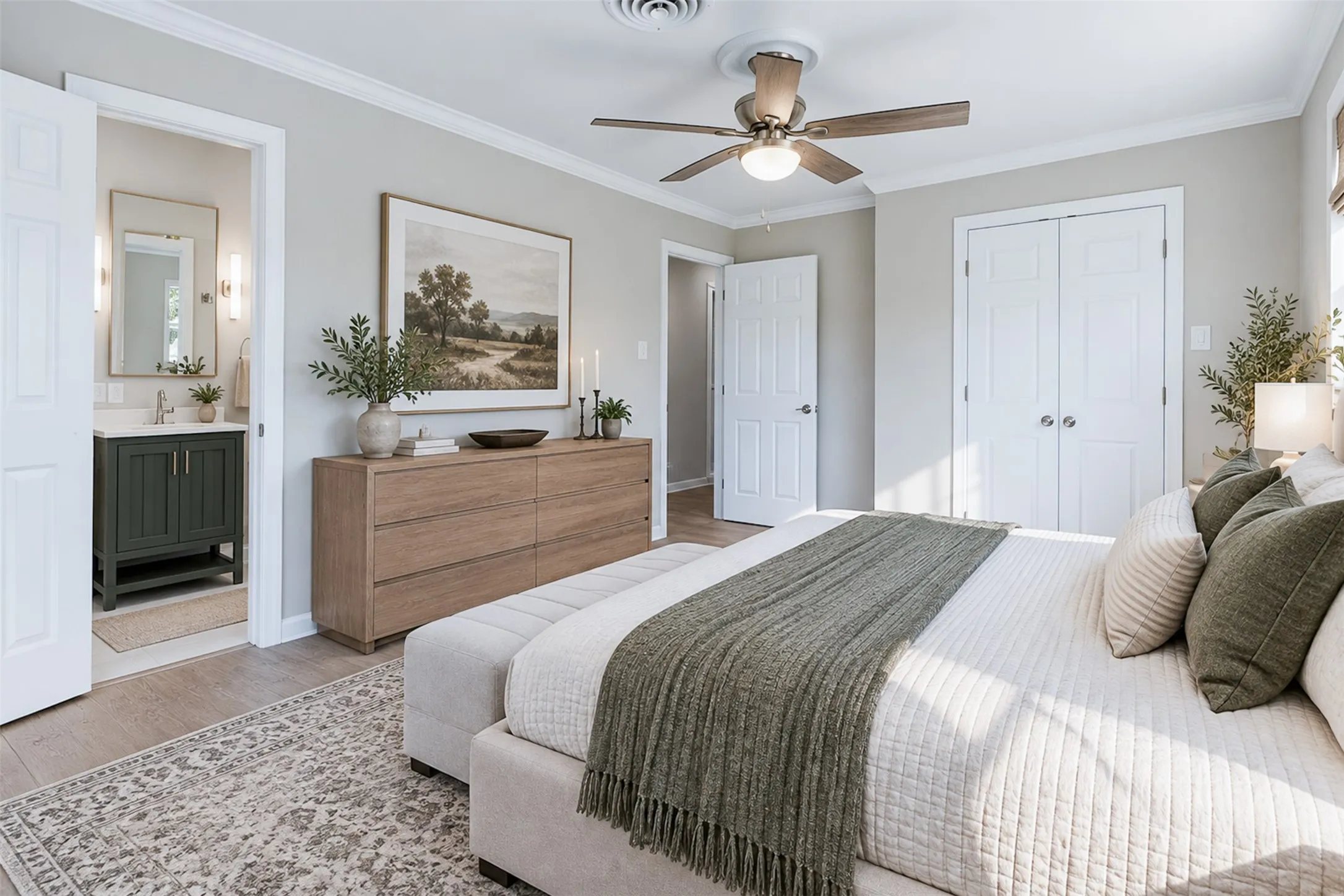 Wood-finish flooring, ceiling fan with integrated lighting, dual bifold closet doors, and crown molding