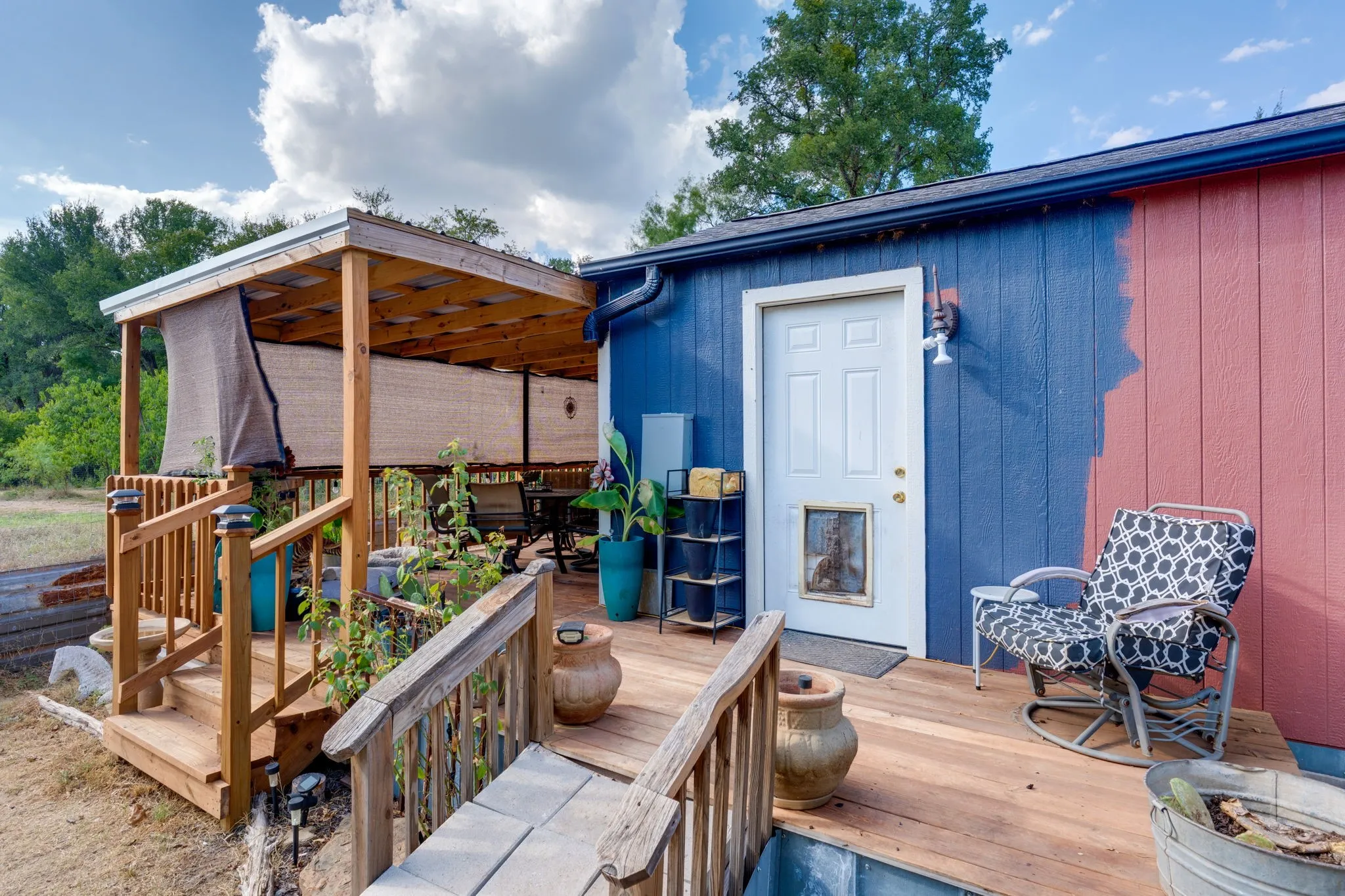 Wood-finish deck with a covered patio structure and exterior door access