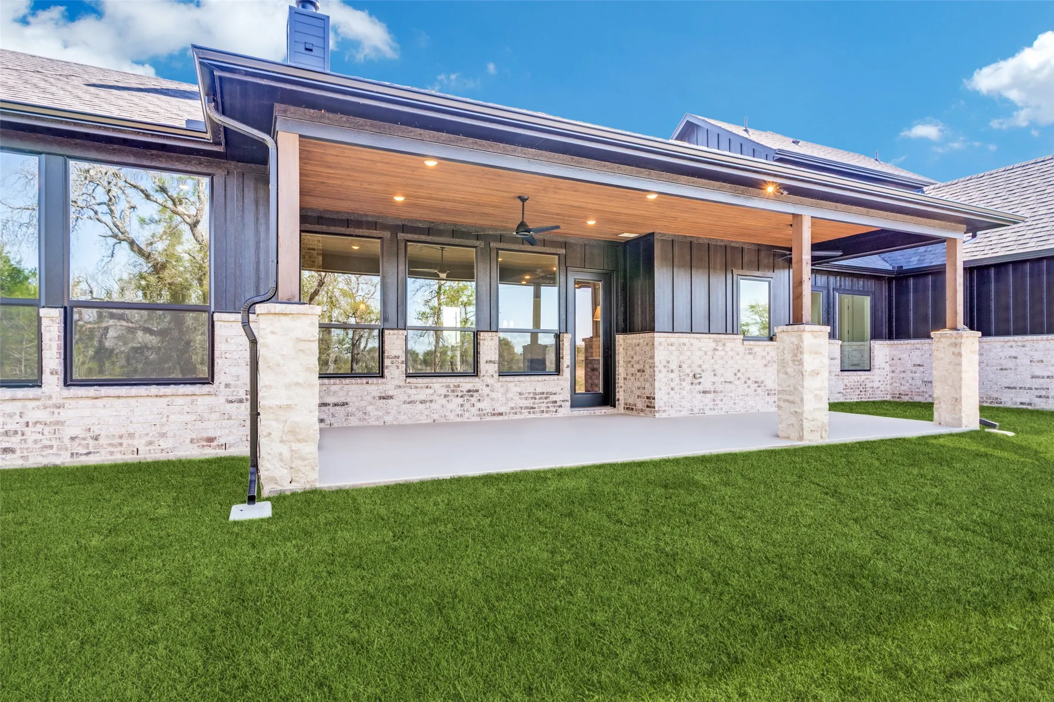 Expansive covered patio with a wood-finish ceiling, recessed lighting, and a ceiling fan