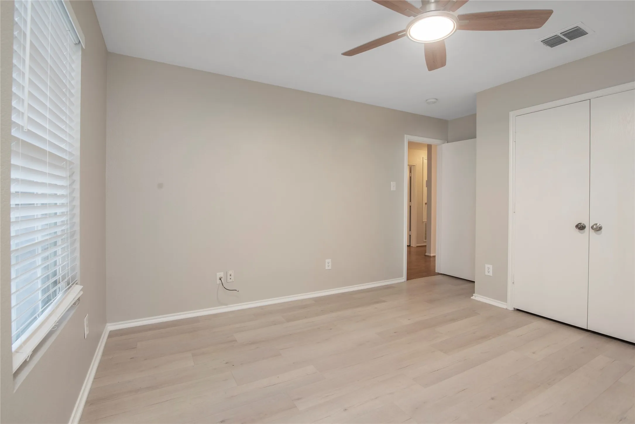 Light wood-finish flooring with neutral wall tones
