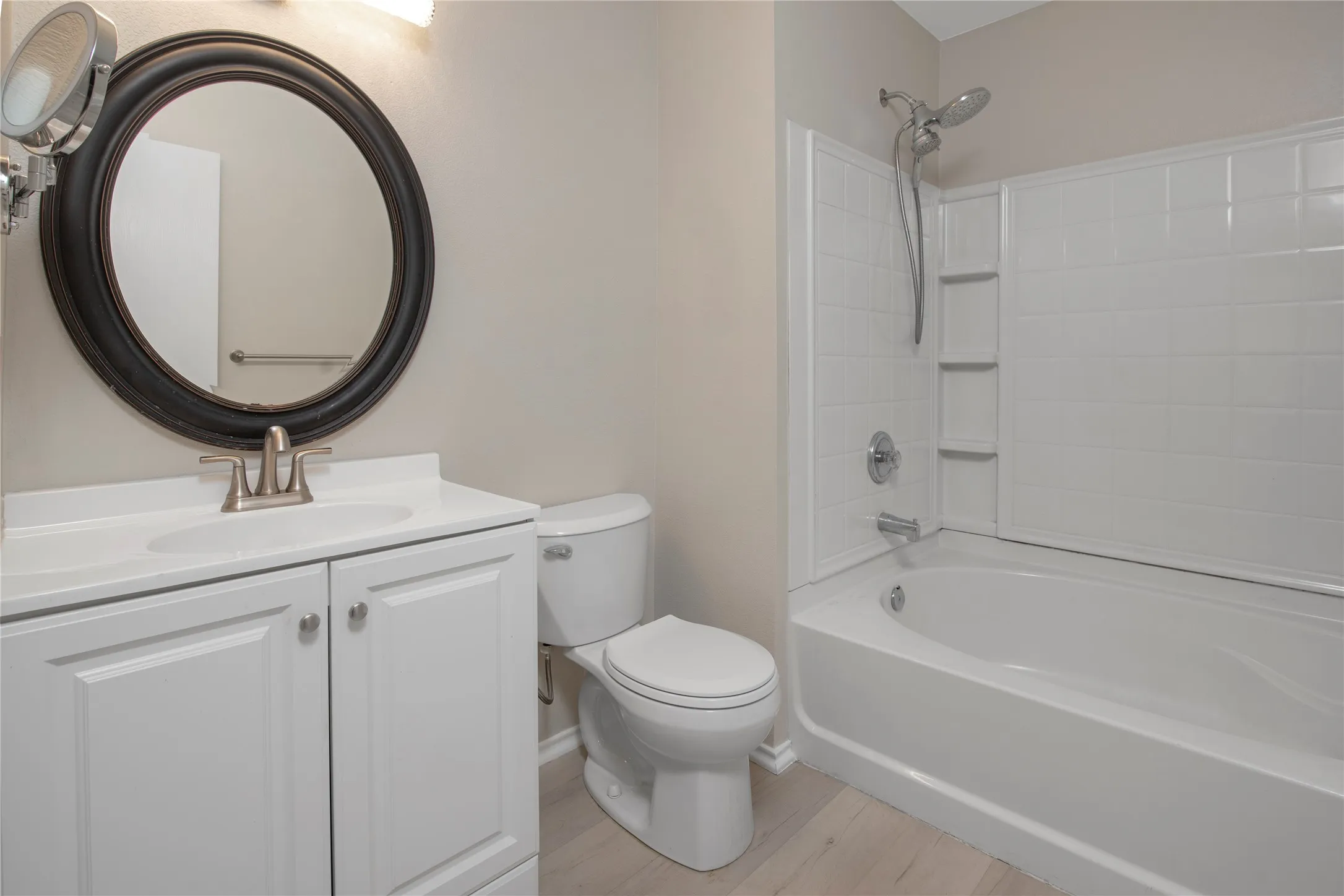 White vanity with brush nickel hardware, white sink, and brush nickel faucet
