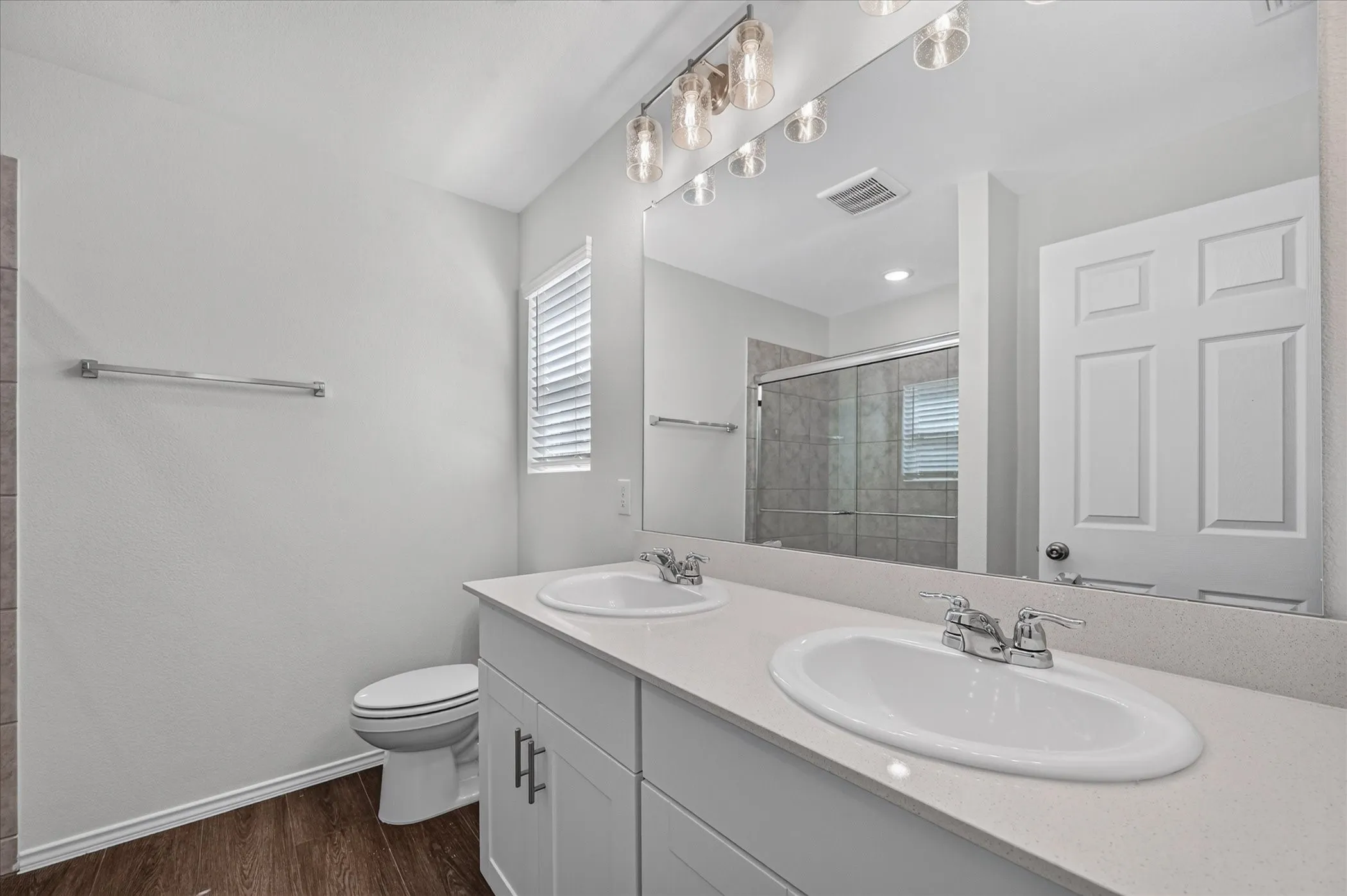 Dual vanity with white cabinetry, light-toned countertop, and undermount sinks