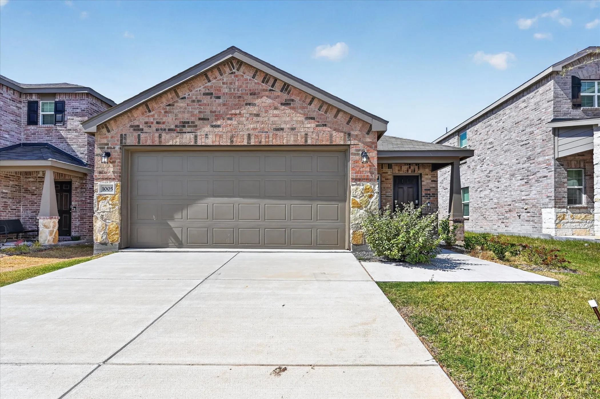 Brick and stone veneer exterior with an attached two-car garage