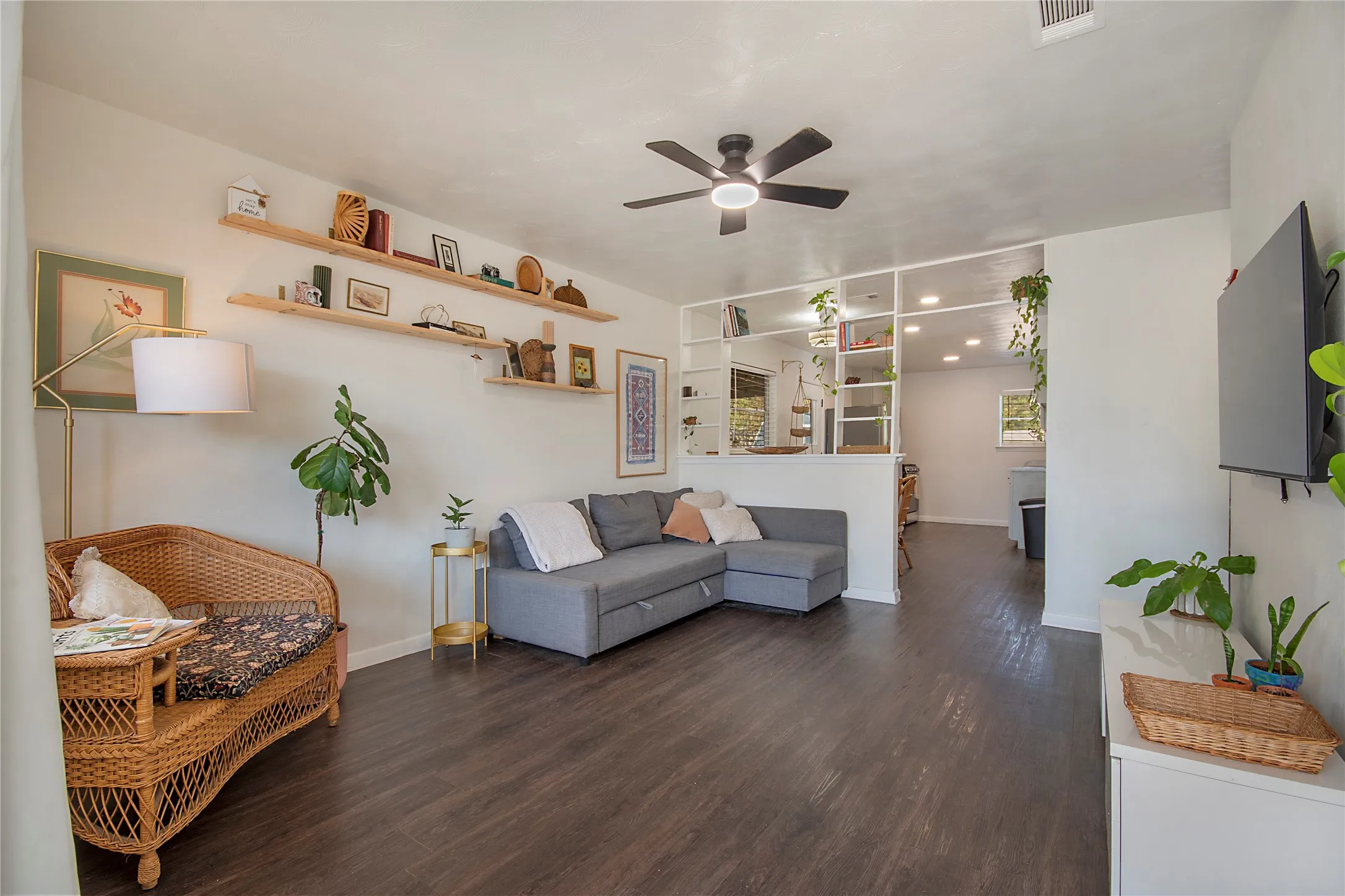 Living area with wood-finish flooring, recessed lighting, and a contemporary ceiling fan