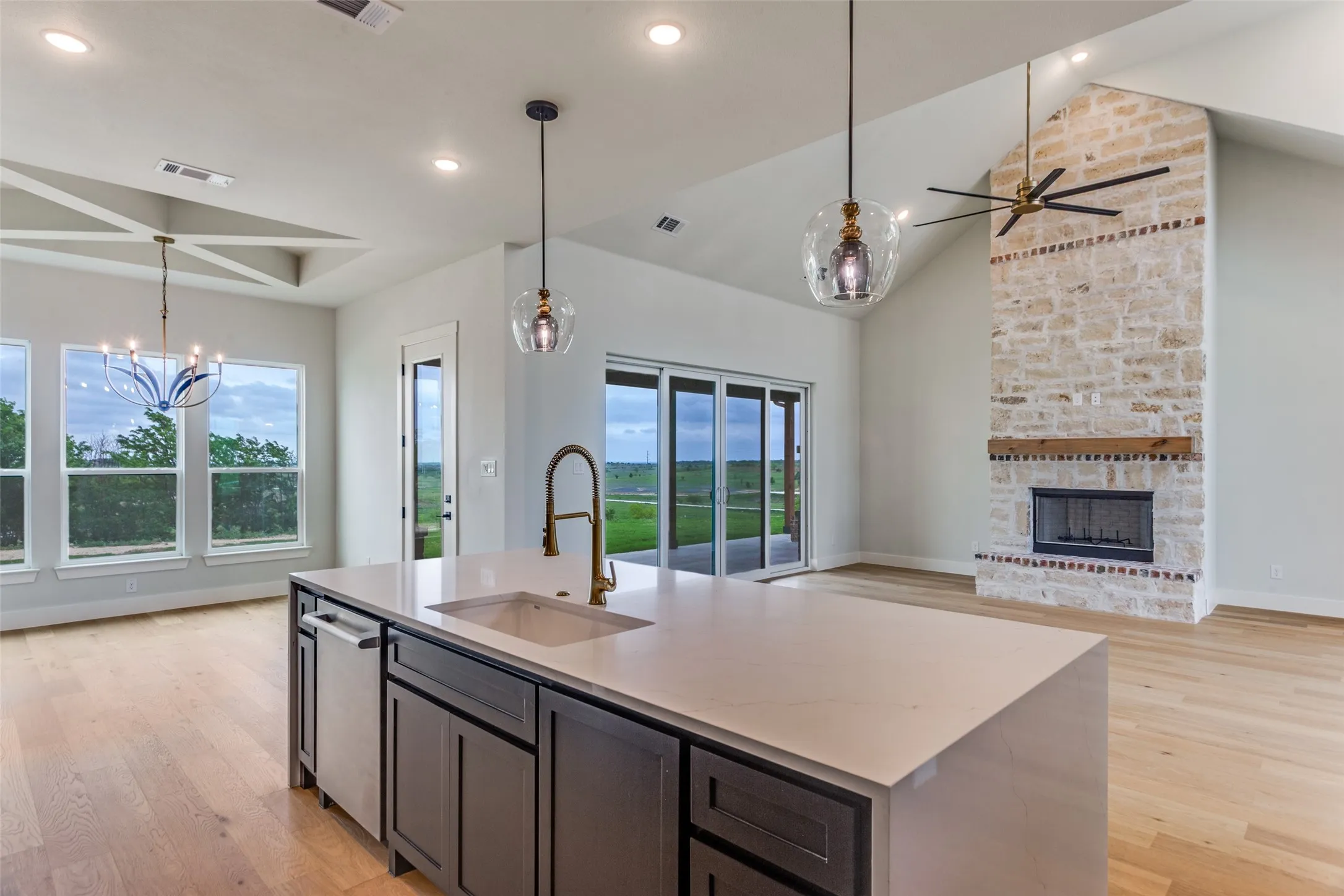 Kitchen island with undermount sink, brass finish faucet, and integrated dishwasher