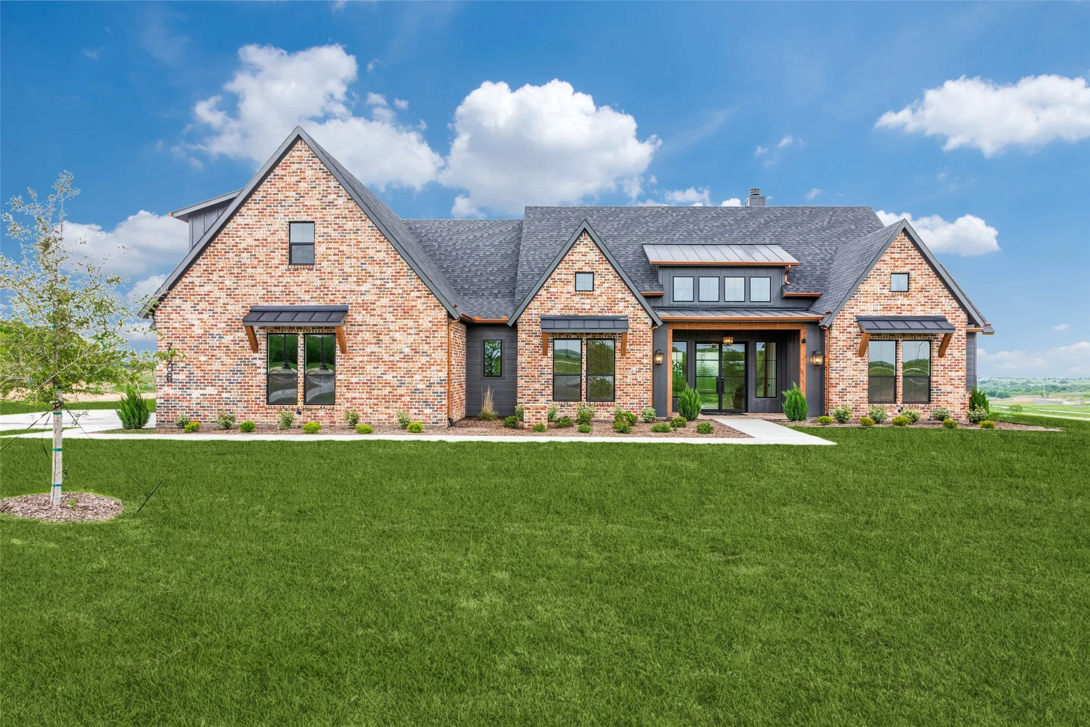 Brick and siding exterior with a dark shingle roof