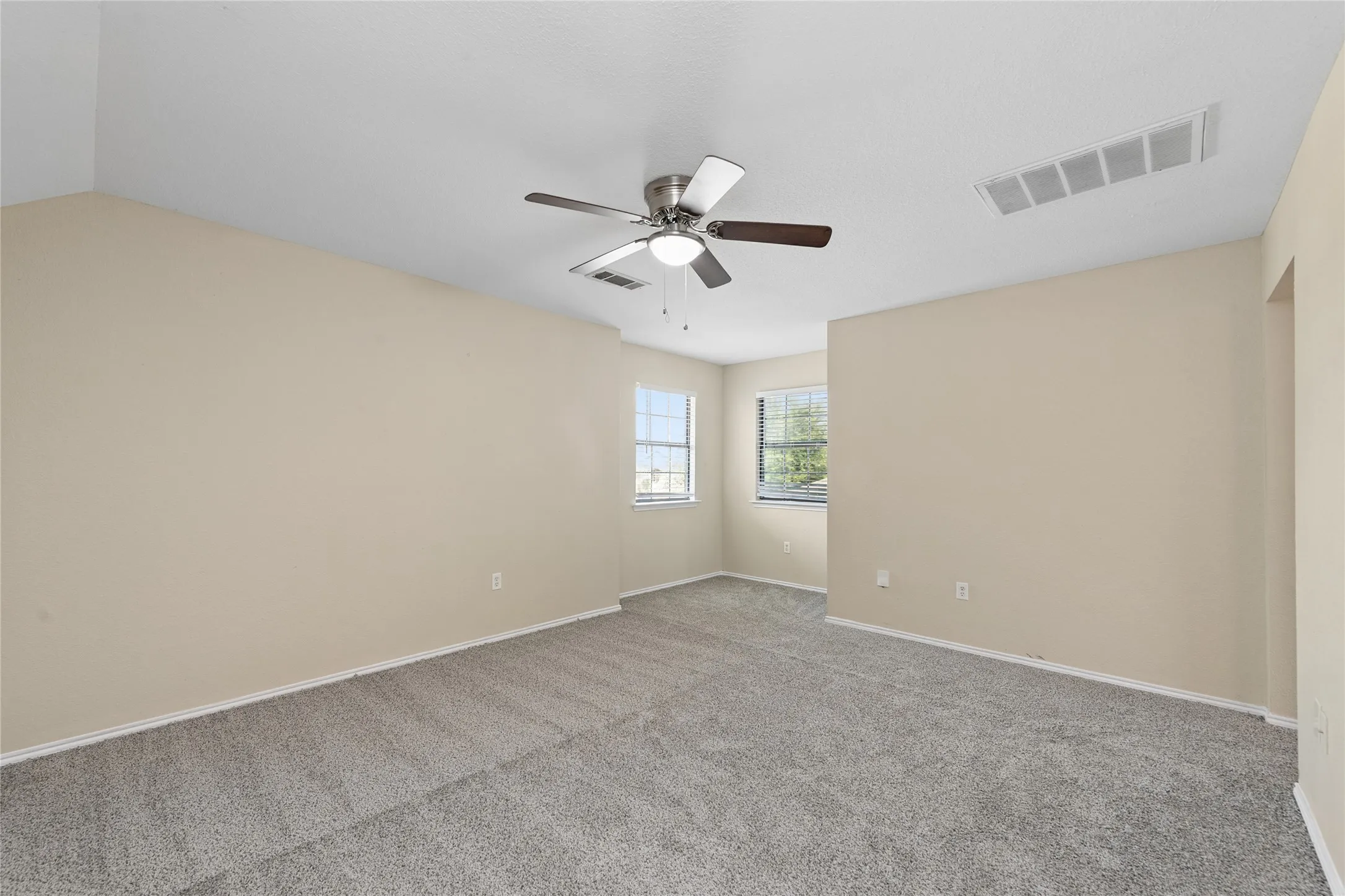Recessed ceiling fan with dual-tone blades, neutral-toned walls, and grey​​‌​​​​‌​​‌‌​‌‌​​​‌‌​‌​‌​‌​​​‌​​ carpeting