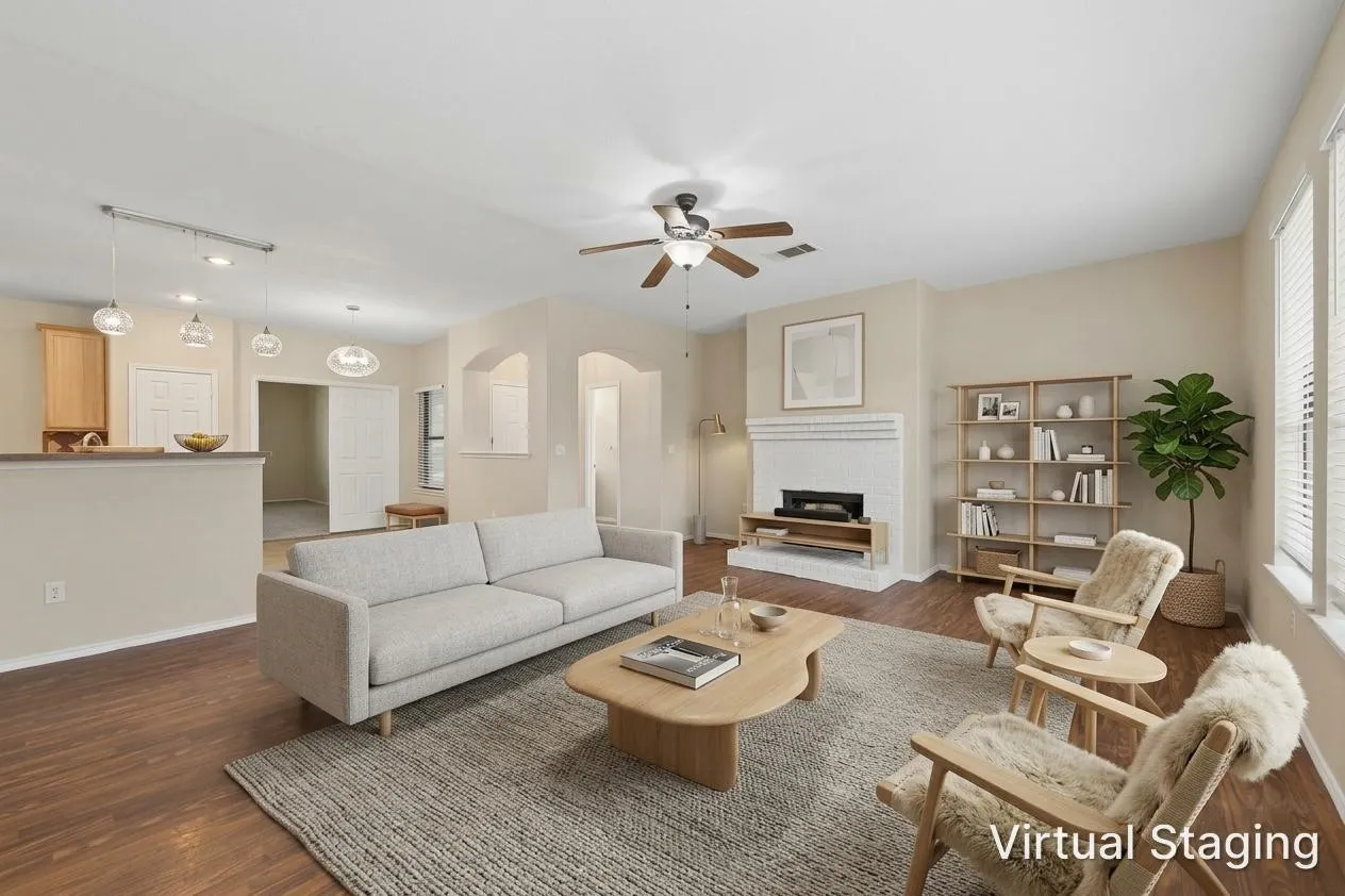 Wood-finish flooring throughout, a ceiling fan with integrated lighting, and a white fireplace with a mantel
