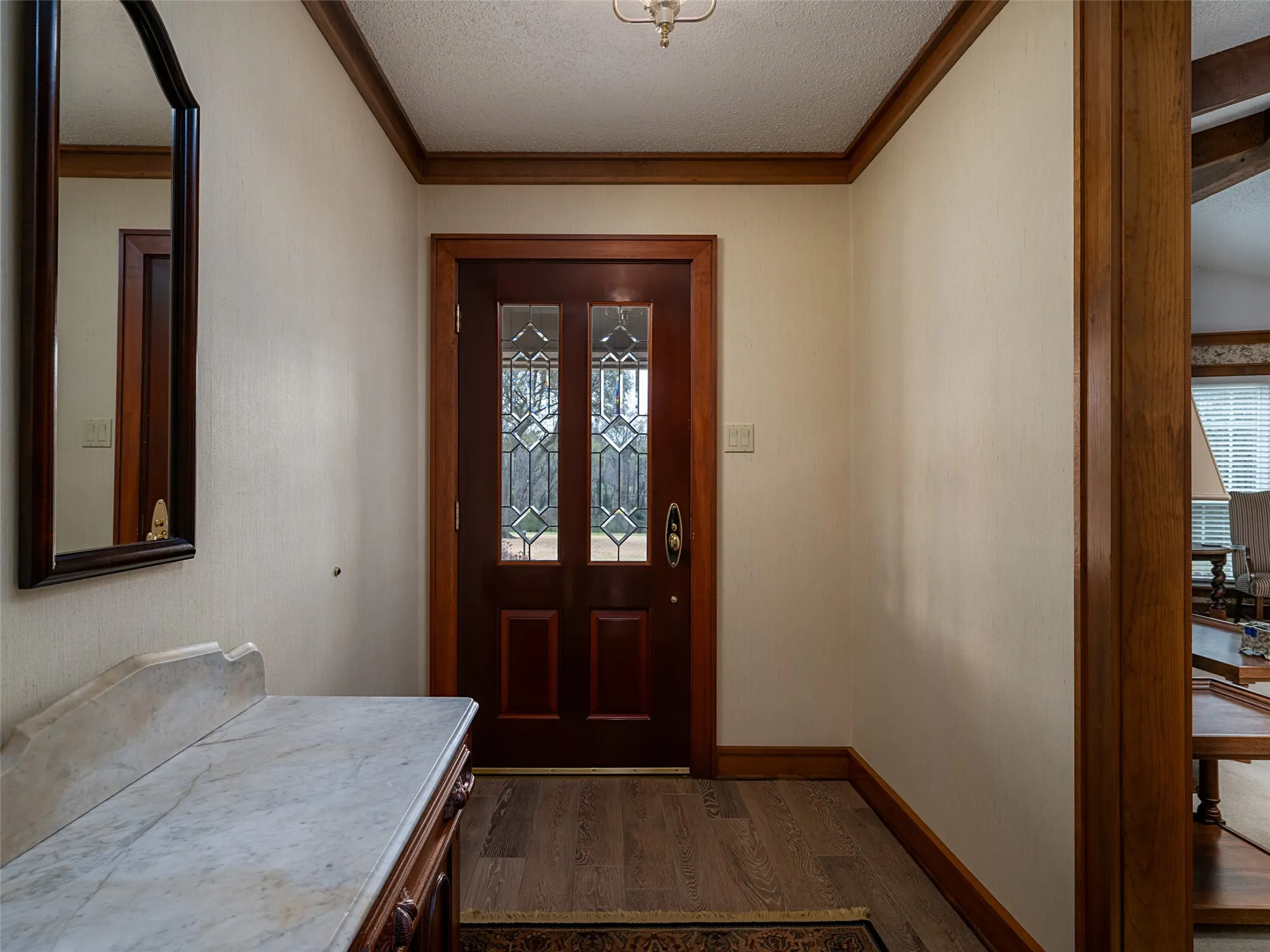 Tiled Wood-finish flooring with a decorative area rug