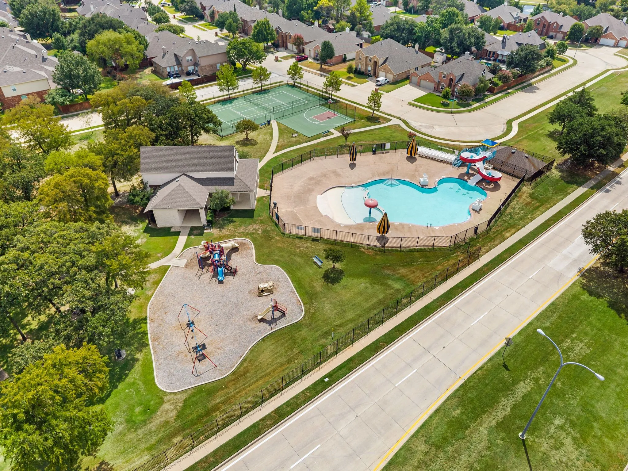 Community amenities featuring a swimming pool, water slides, tennis courts, and a playground