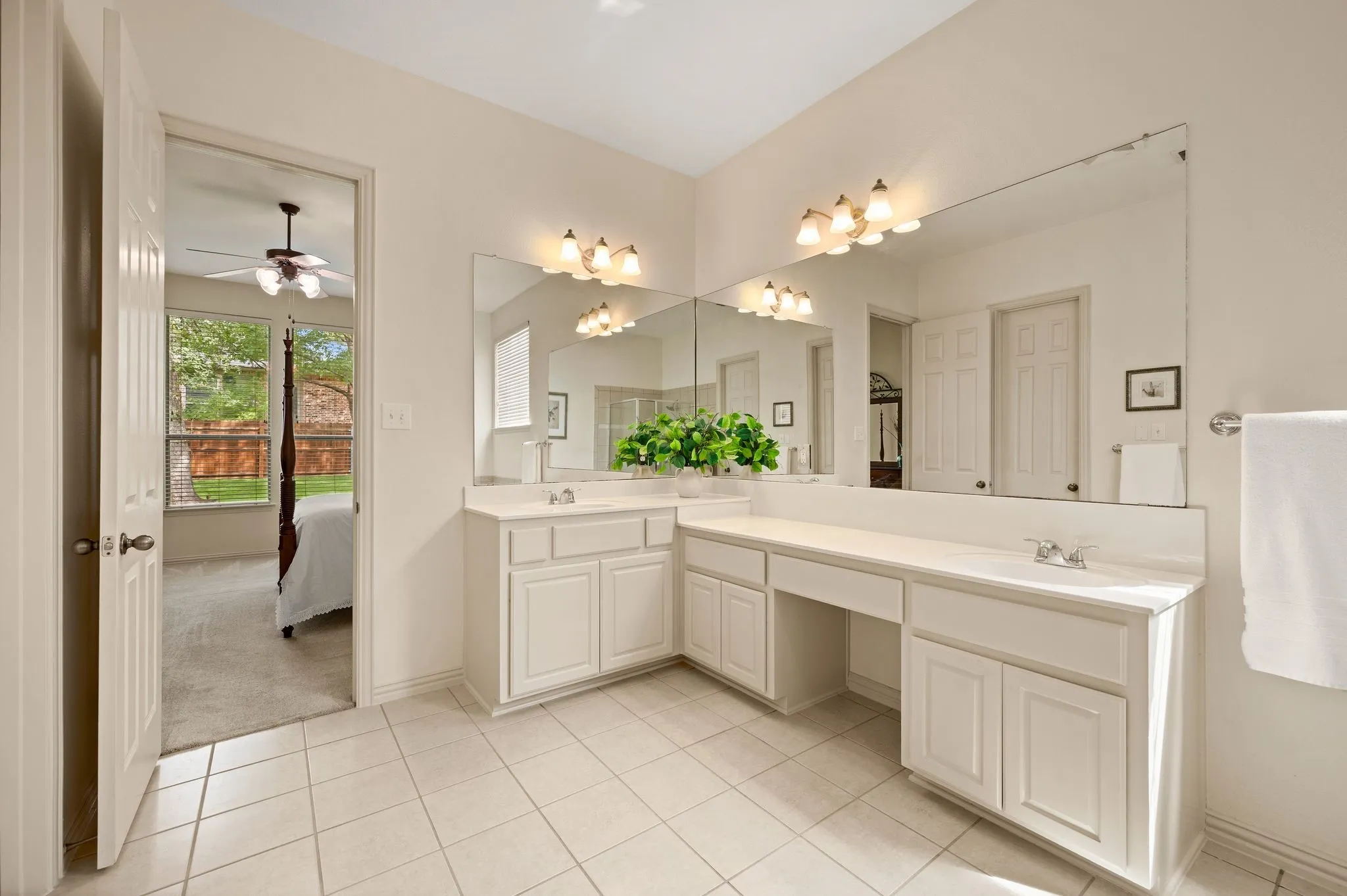 Tile flooring and a spacious vanity with dual sinks