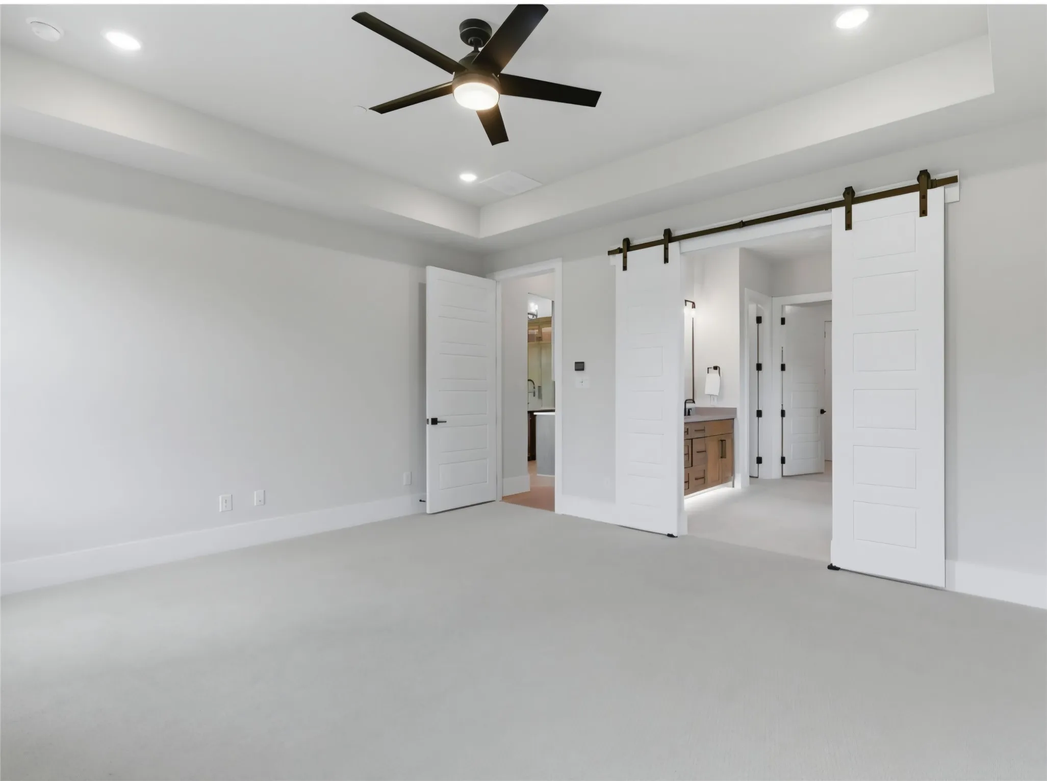 Coffer ceiling with recessed lighting and a ceiling fan