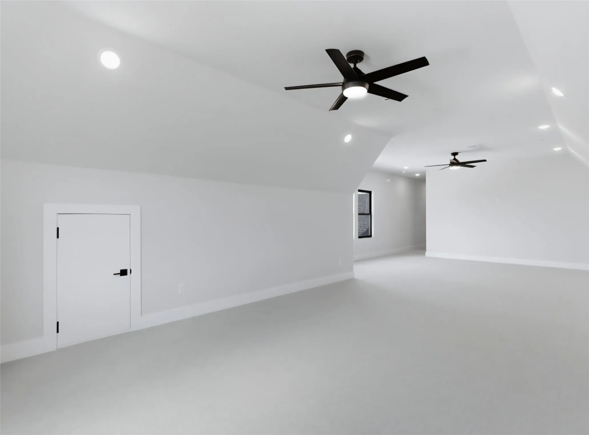 Expansive room featuring vaulted ceilings, recessed lighting, and two ceiling fans