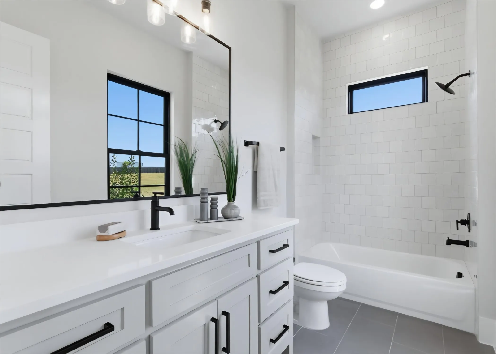 Vanity with white countertop, undermount sink, and matte black faucet