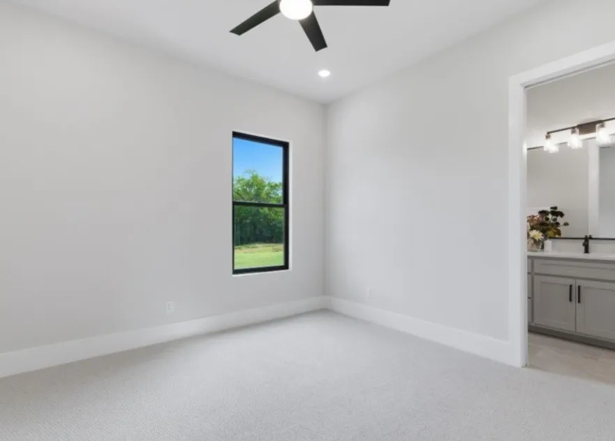 Carpeted room with a black ceiling fan, recessed lighting, and a window