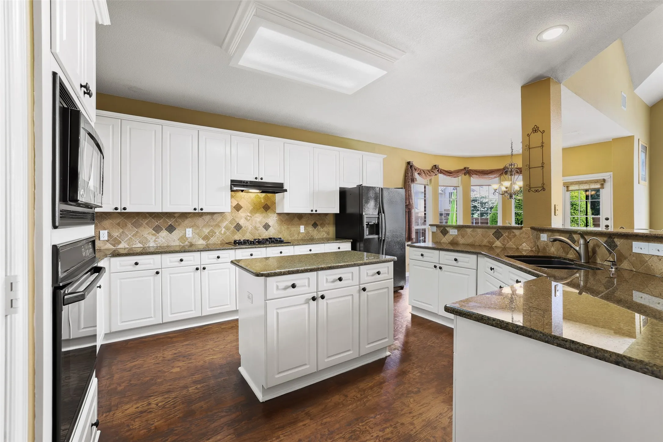 Dual islands with granite counters offer lots of space to cook and eat!