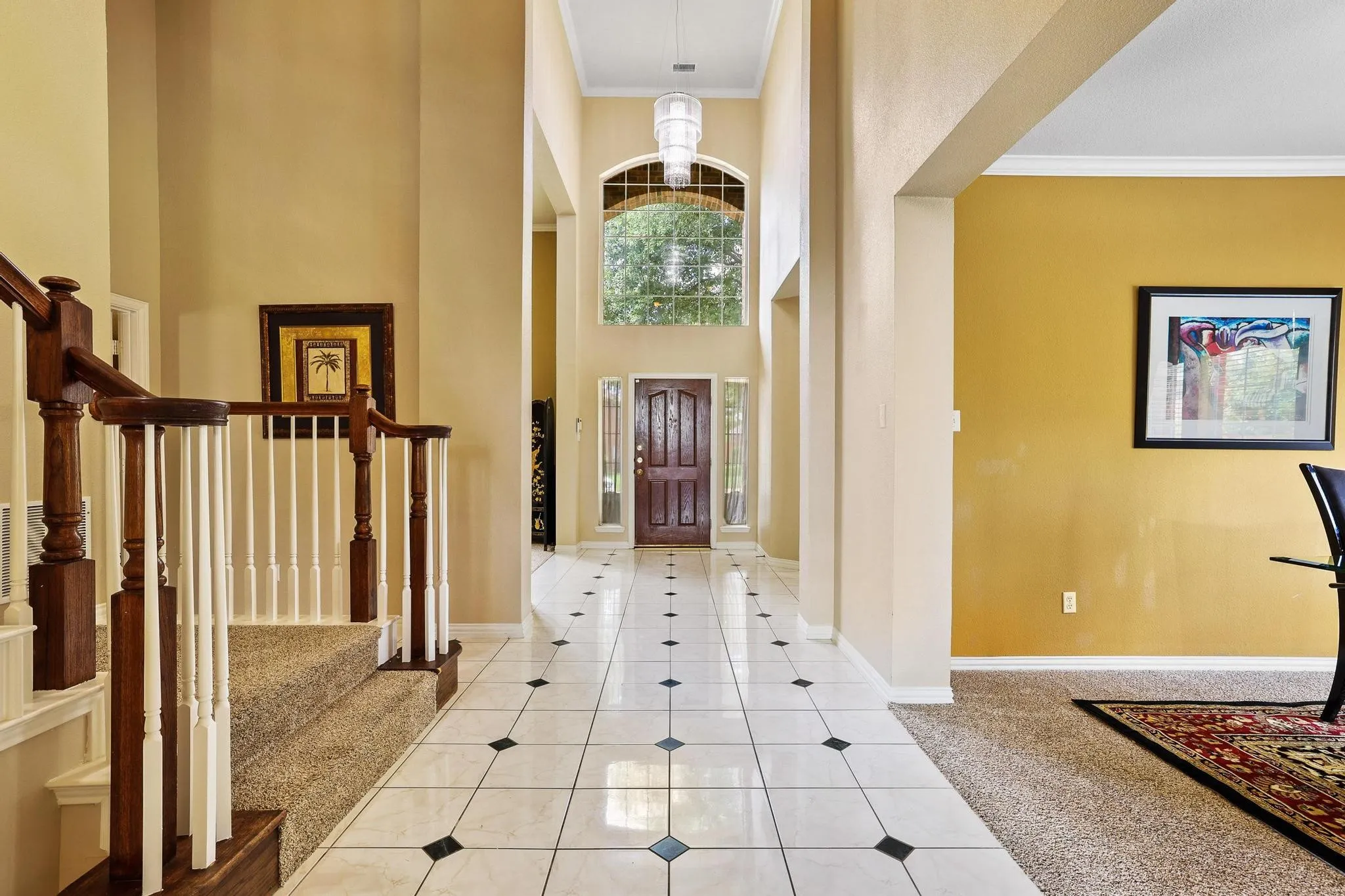 Inlaid tile floor and soaring ceiling makes a grand entrance!