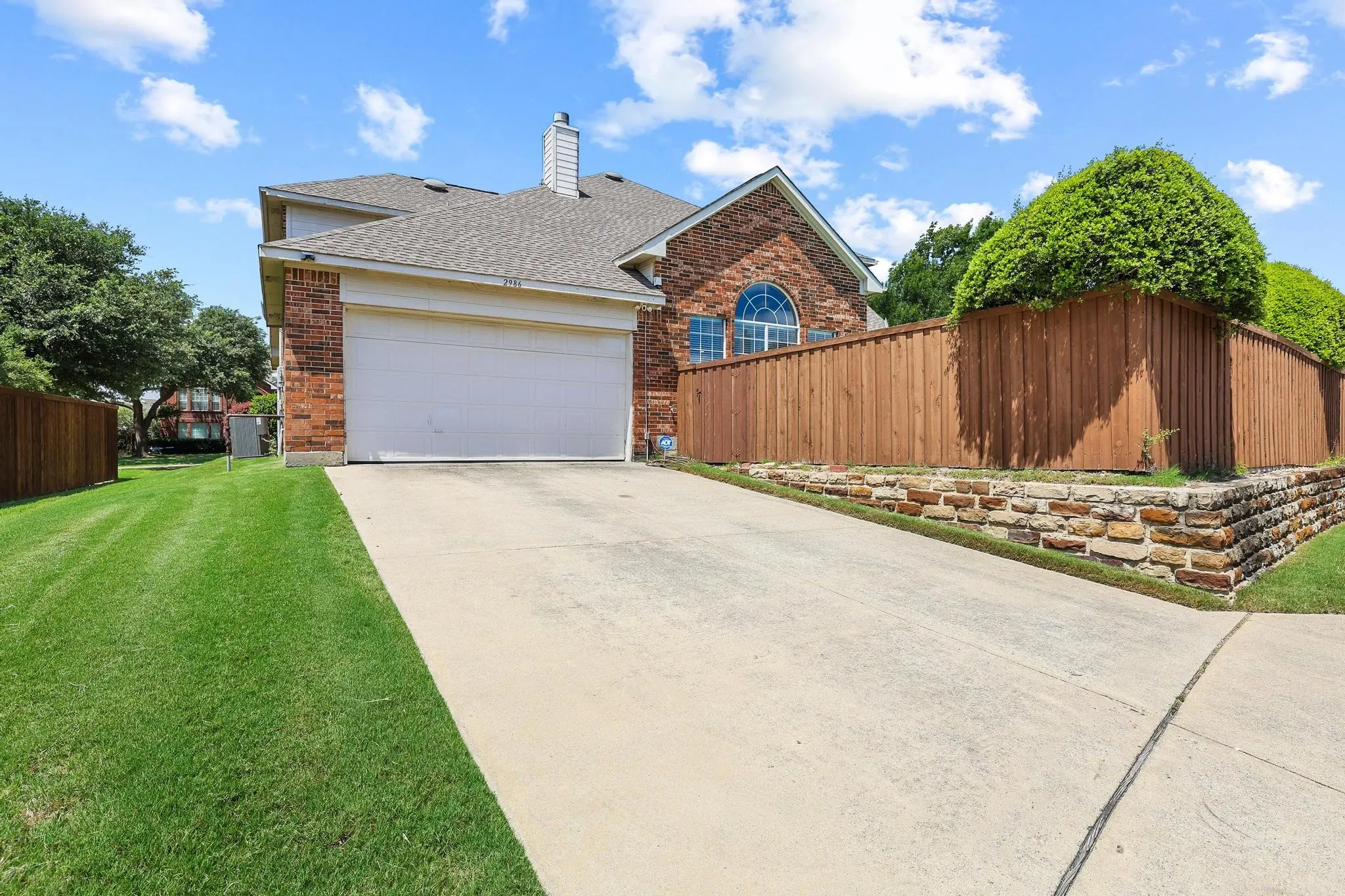 Private alley entrance to the two-car garage and privacy fence