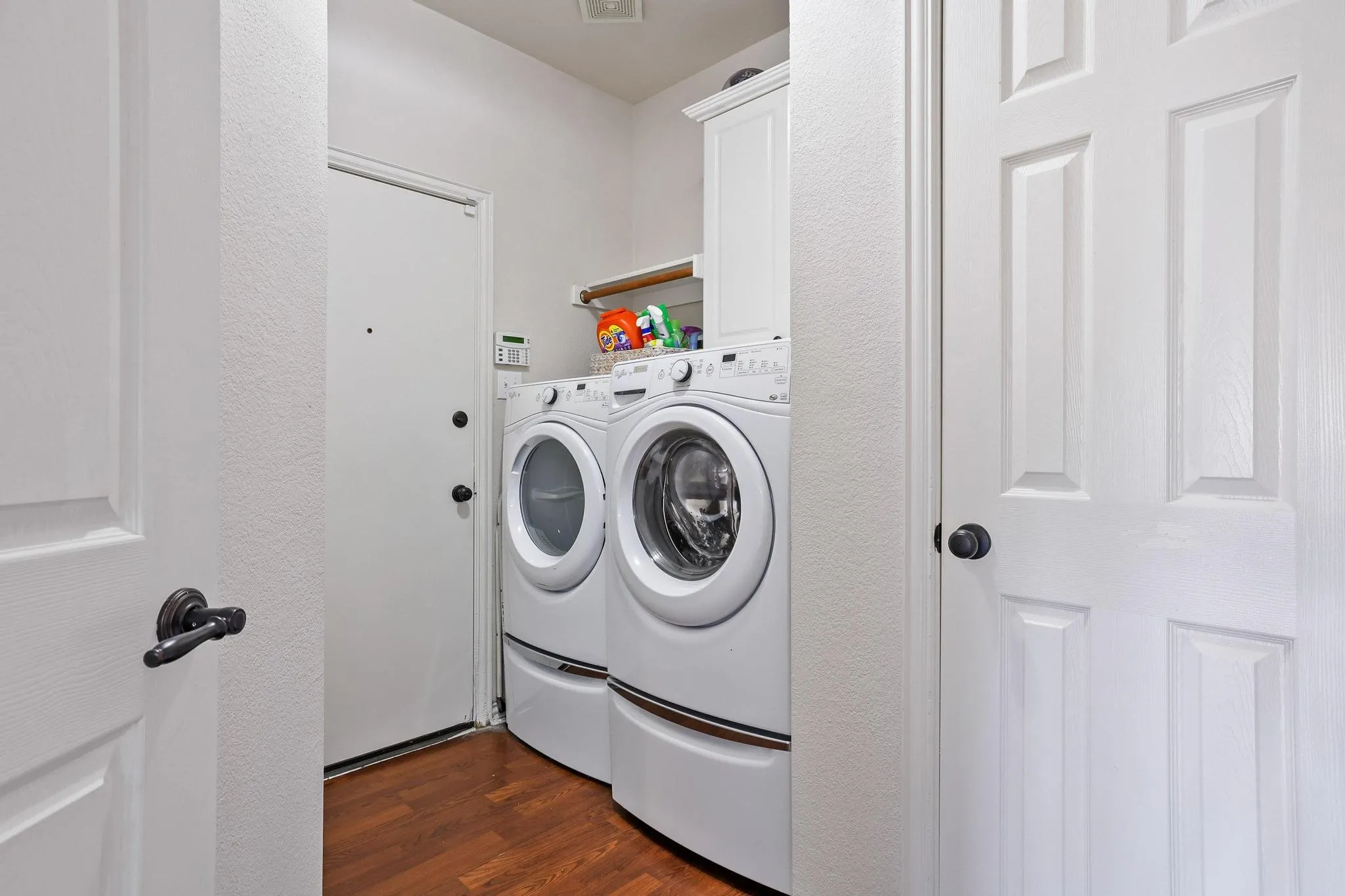Full laundry room with extra storage cabinets and closet