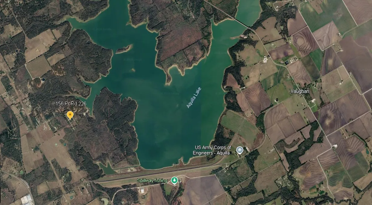 Satellite Imagery. Displaying an overhead perspective of Aquilla Lake, surrounding agricultural fields, and a marked property location